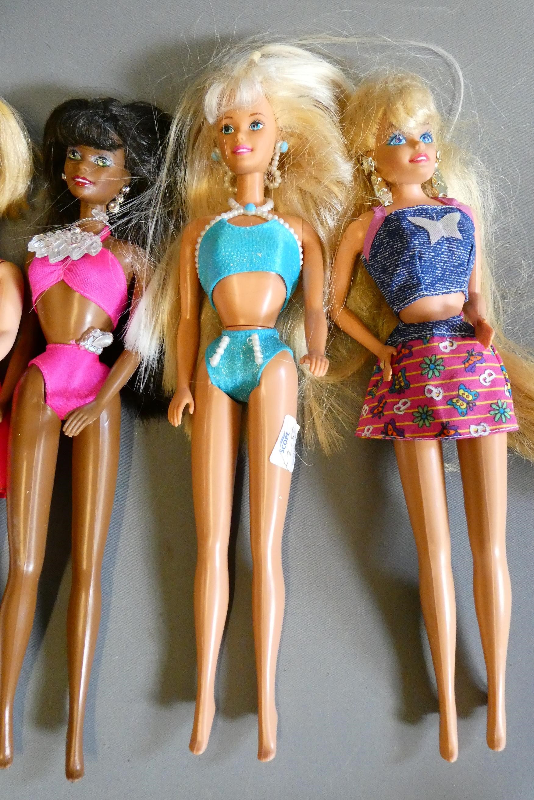 Ten Barbie dolls, including one fully jointed ballet Barbie and one with pull string spinning Image