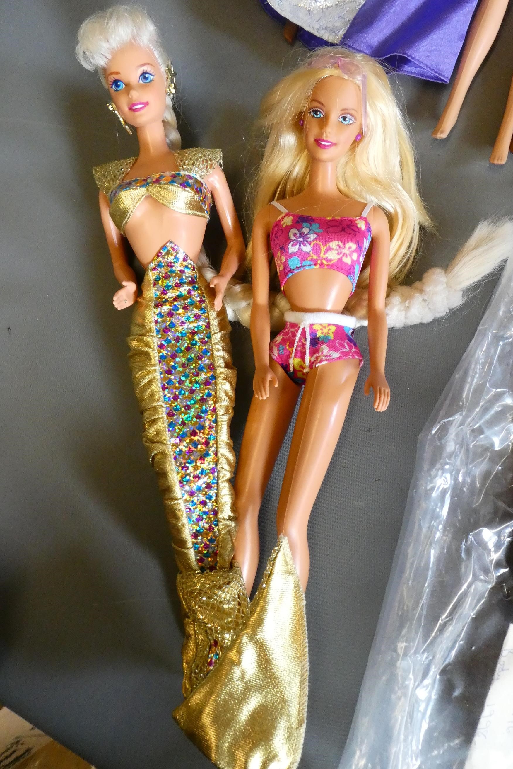 Ten Barbie dolls, including one fully jointed ballet Barbie and one with pull string spinning Image