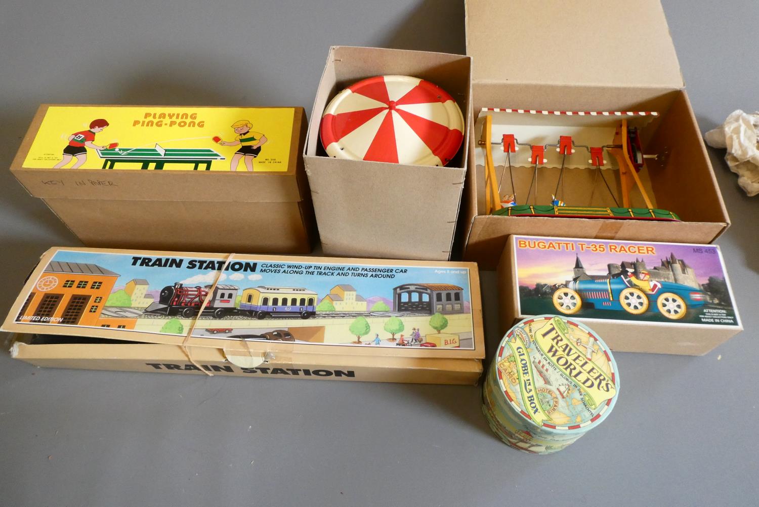 Five late issue China made tinplate clockwork toys, and a novelty globe, all items boxed, excellent Image