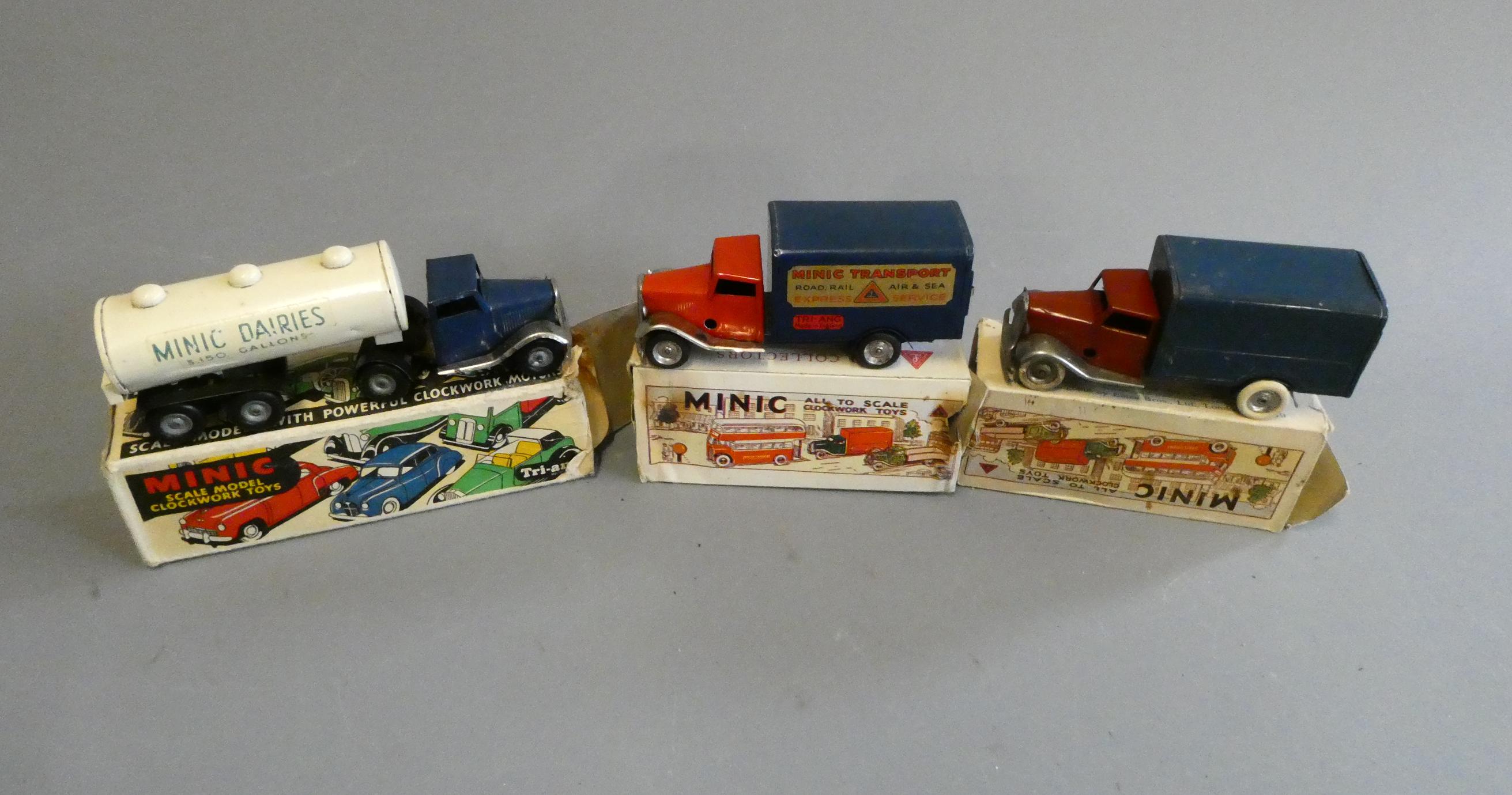 Three Triang Minic clockwork lorries comprising two delivery wagons and milk tanker. All items Image