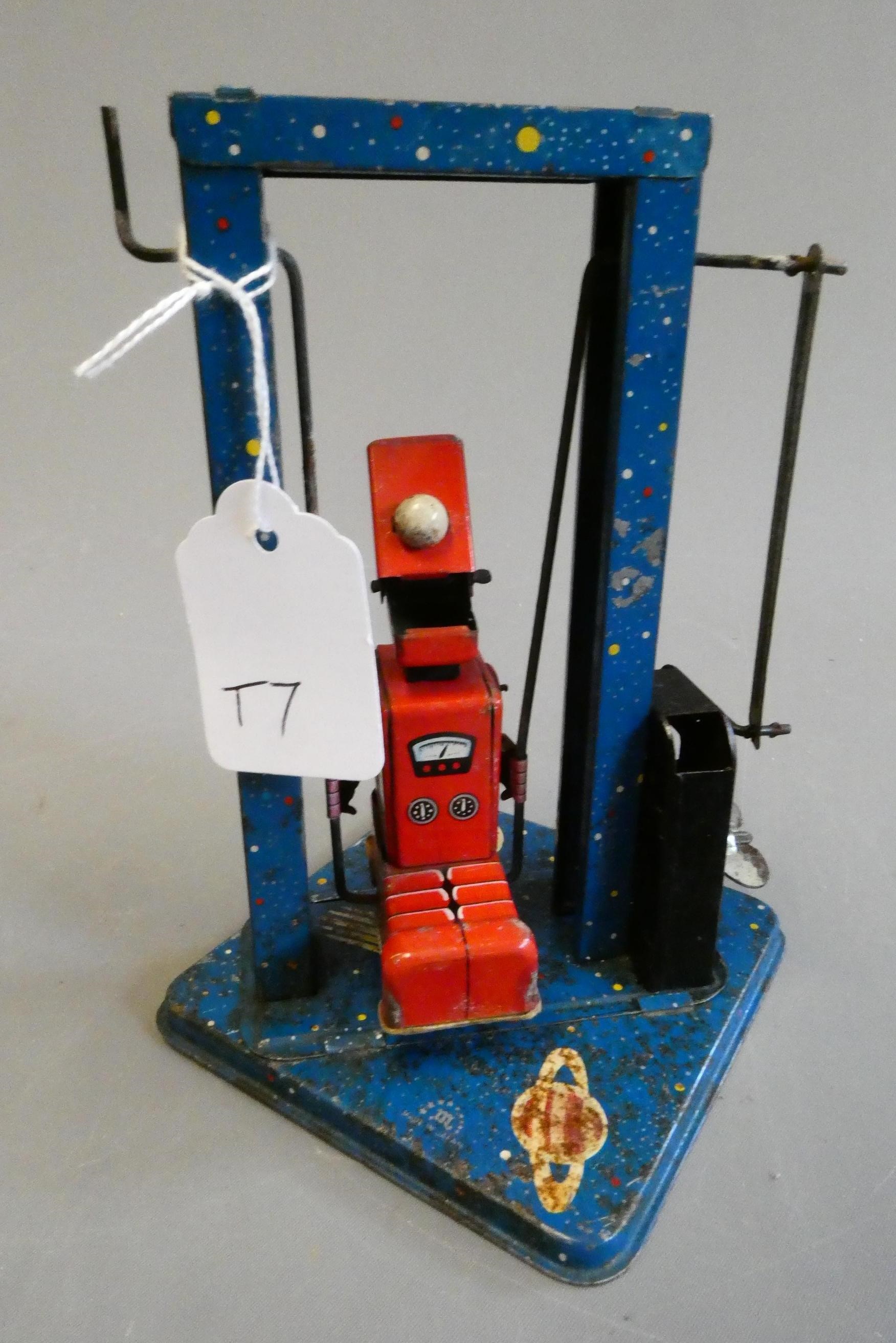 Mikuni clockwork toy robot on a swing, some minor paint loss and rust on base, fair (Est. plus 24% Image