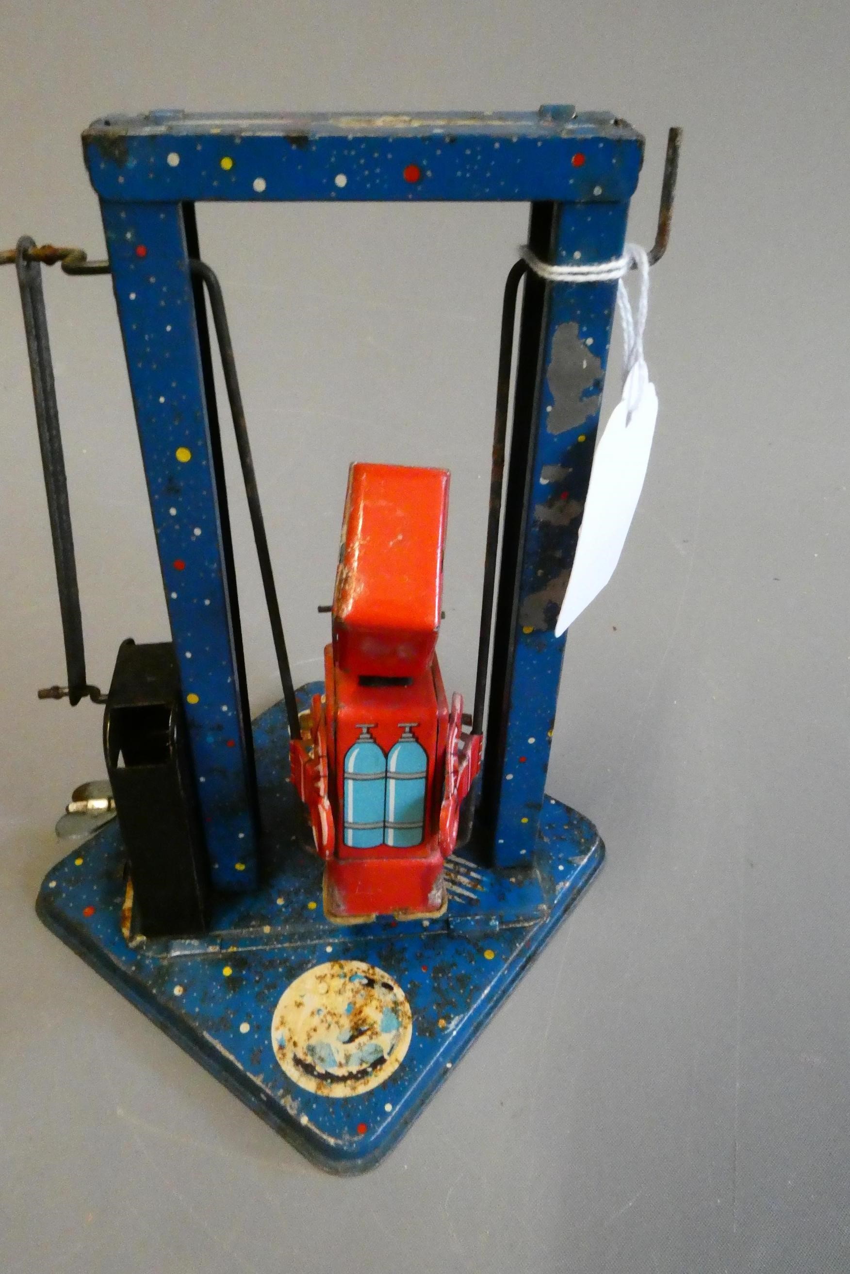 Mikuni clockwork toy robot on a swing, some minor paint loss and rust on base, fair (Est. plus 24% Image