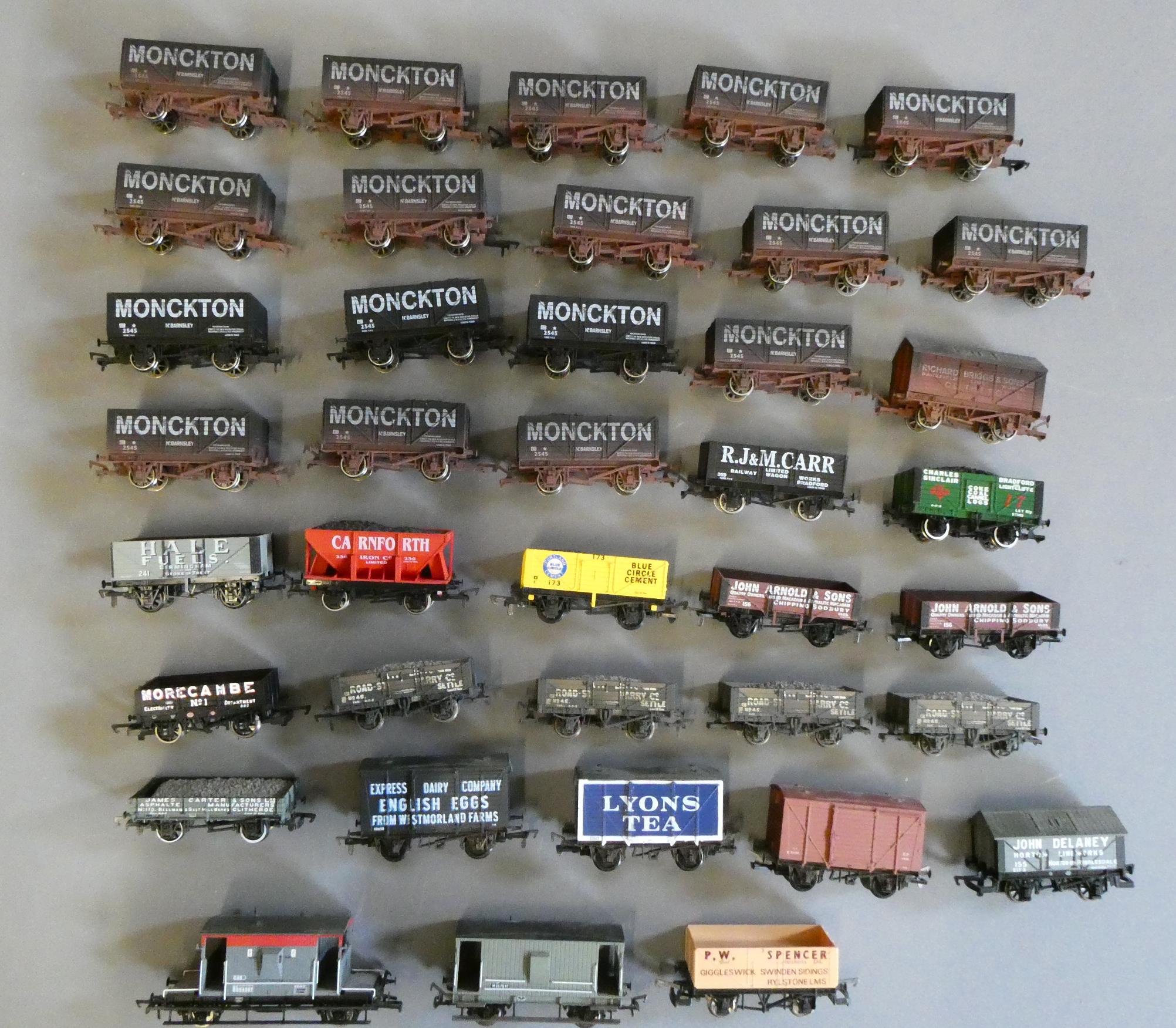 Forty unboxed goods trucks by Dapol Image