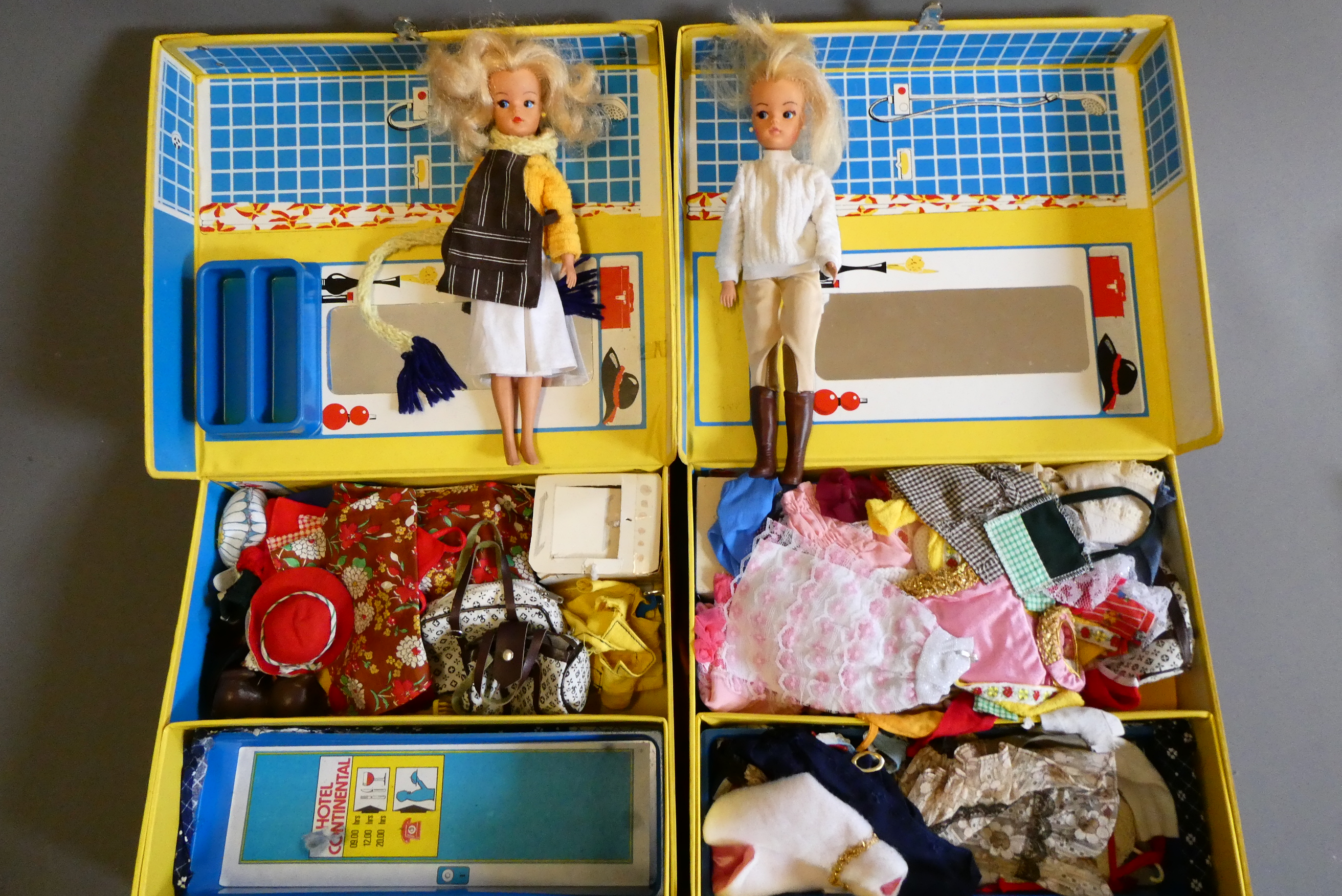 Two Sindy cases containing two Sindy dolls and a large quantity of clothing and accessories (Est. Image
