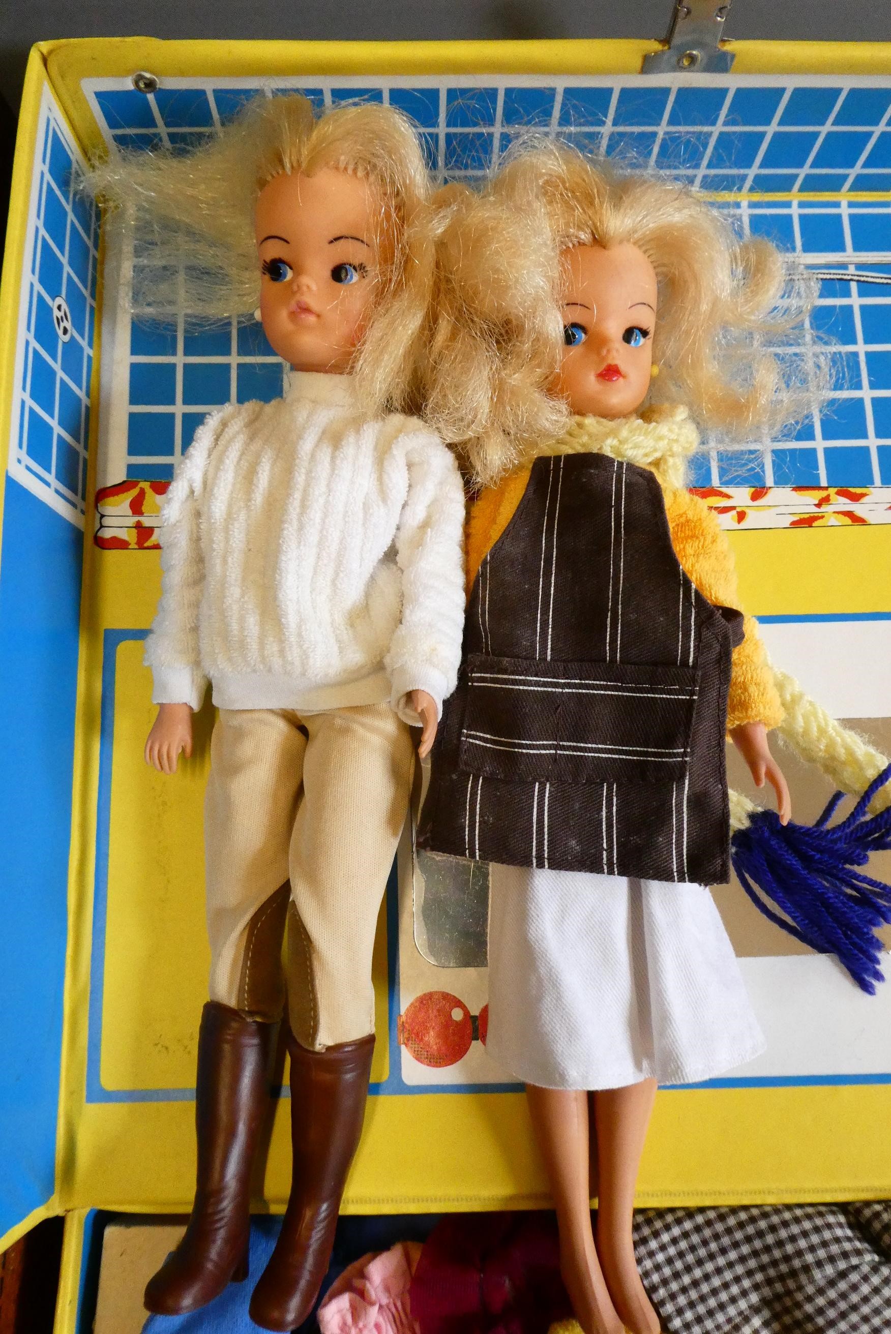 Two Sindy cases containing two Sindy dolls and a large quantity of clothing and accessories (Est. Image