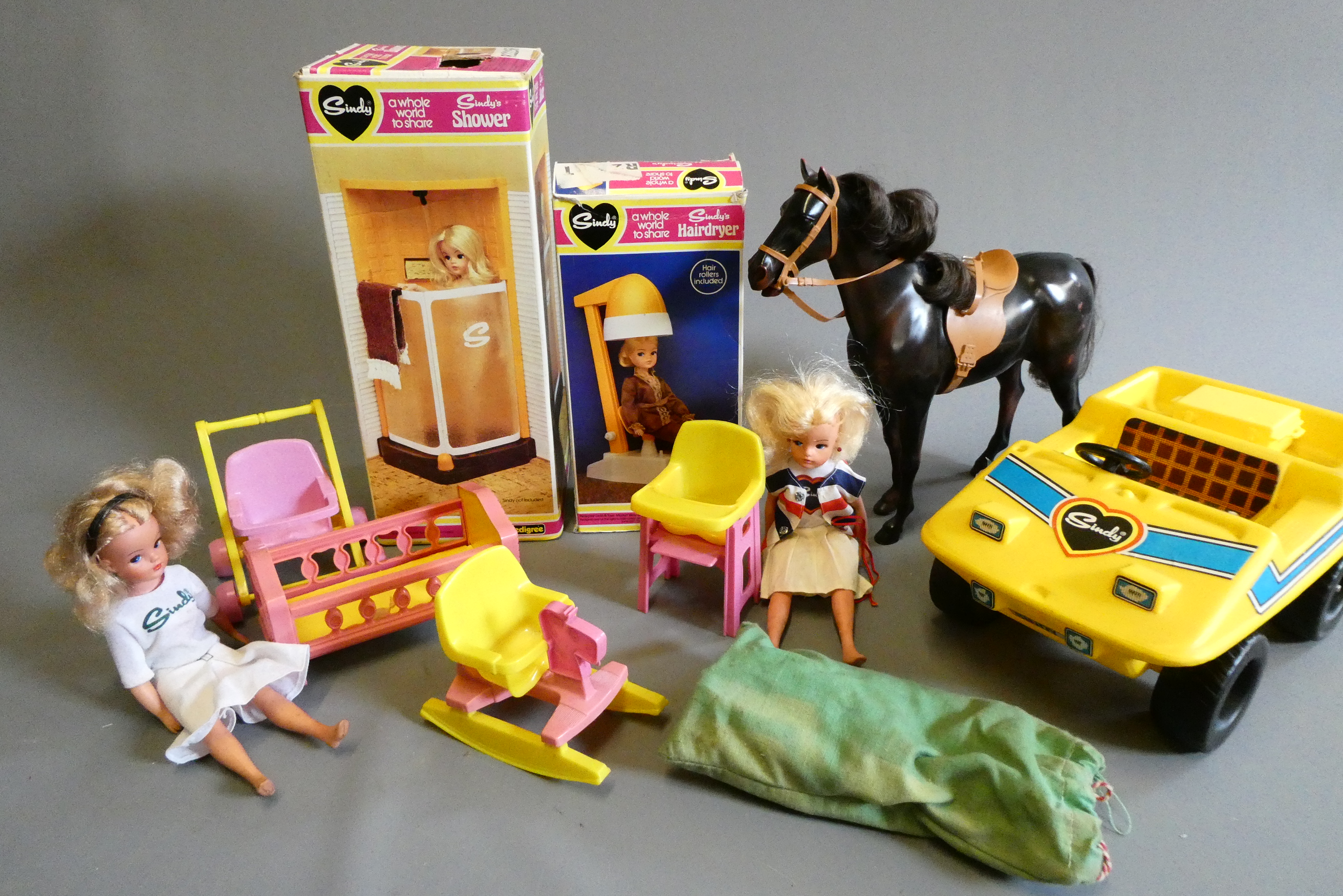 A box of Sindy doll items, including two dolls, one boxed shower, one boxed hair dryer, a horse and Image