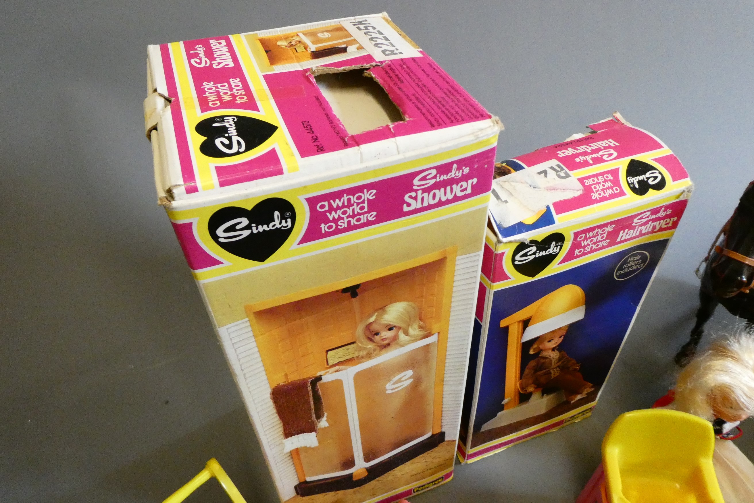 A box of Sindy doll items, including two dolls, one boxed shower, one boxed hair dryer, a horse and Image