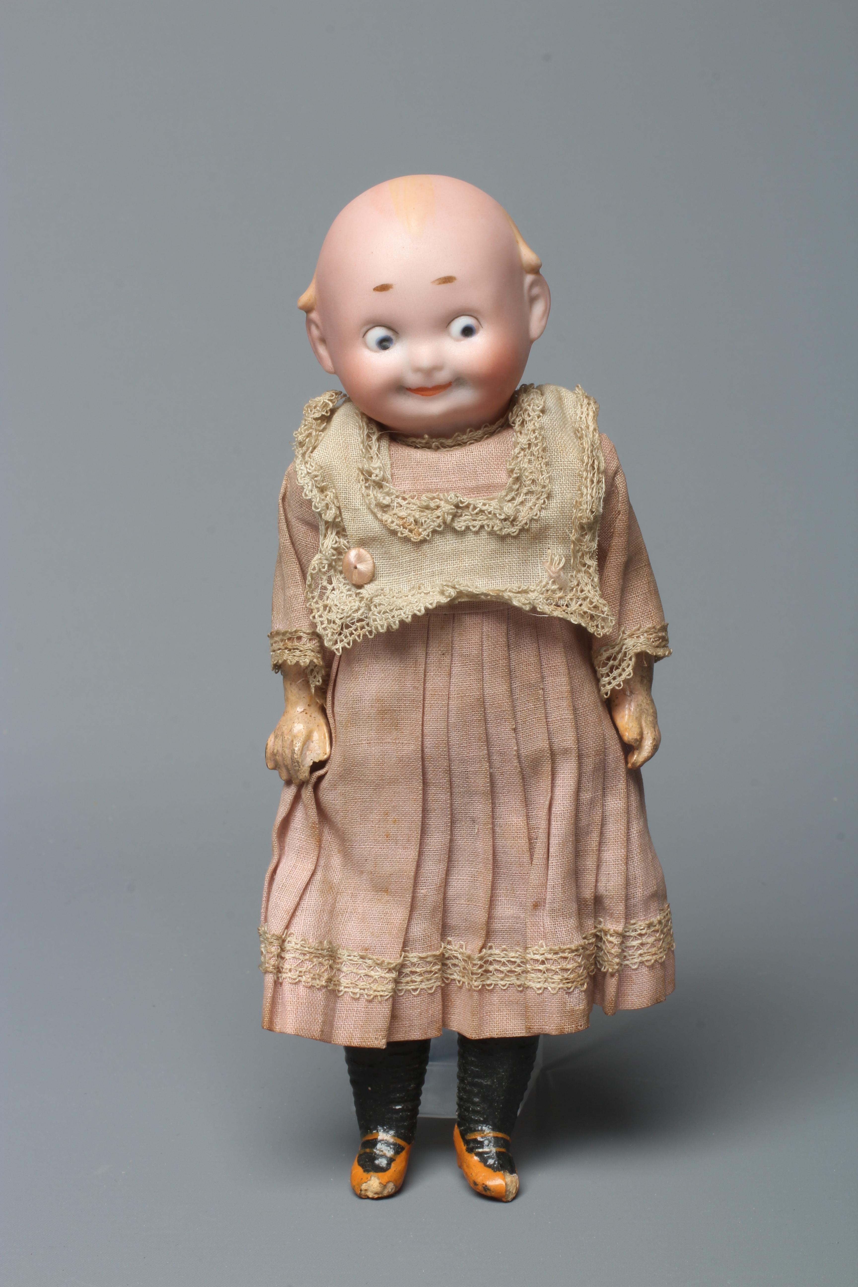 A bisque socket head googly eyed character doll Image