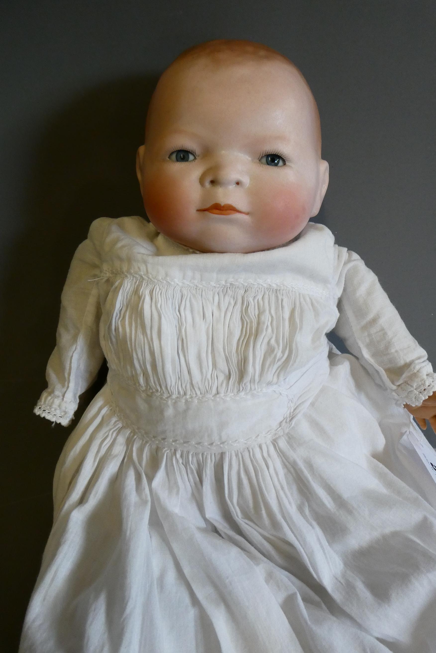 A Grace Putnam flange neck baby doll, with blue glass sleeping eyes, closed mouth, moulded and Image