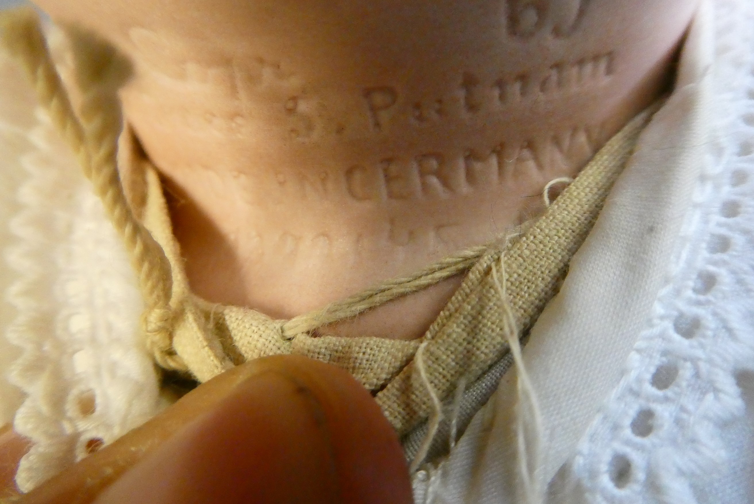 A Grace Putnam flange neck baby doll, with blue glass sleeping eyes, closed mouth, moulded and Image