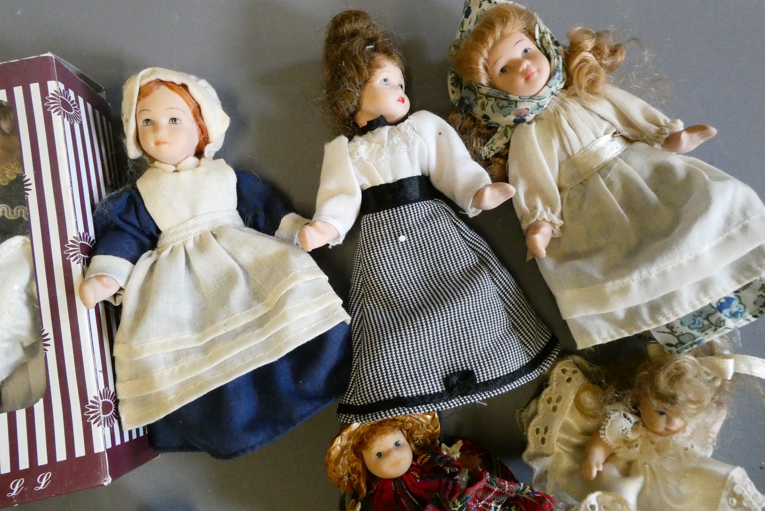 Eight doll's house dolls, seven of which all bisque, and one with fabric body, one boxed and all in Image