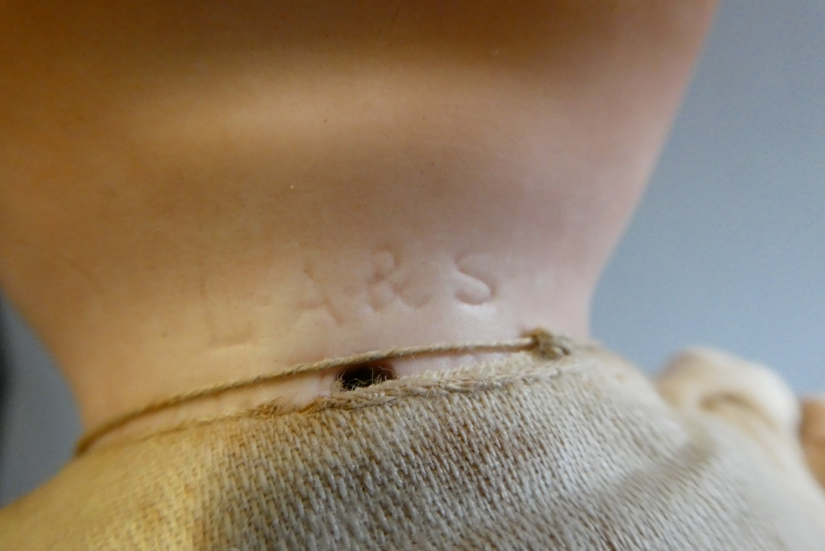 A Louis, Amberg & Son bisque flange neck baby doll, with fabric body and composition hands, numbered Image