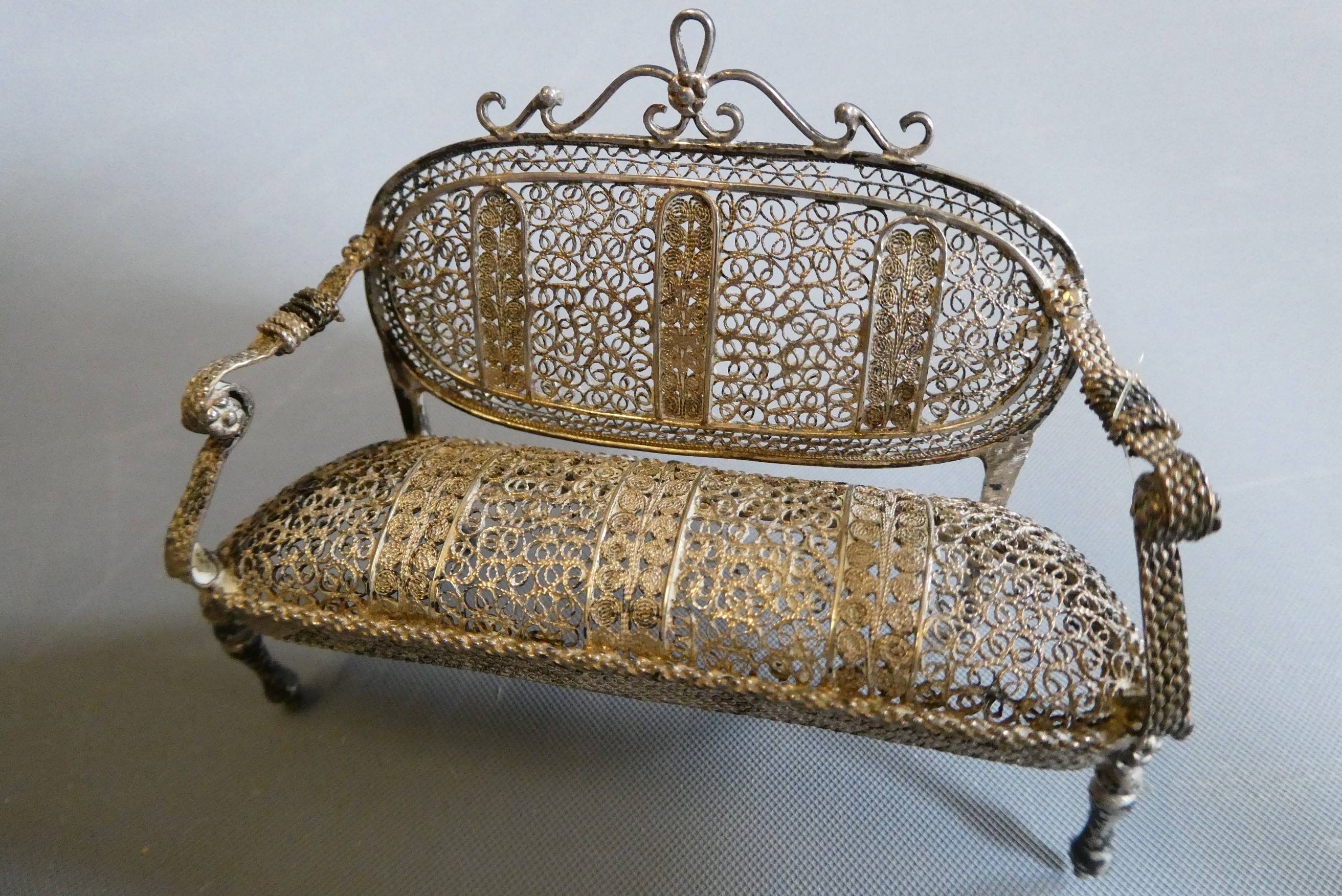 Antique filigree white metal doll's house furniture comprising two chairs, a settee and a pedestal Image