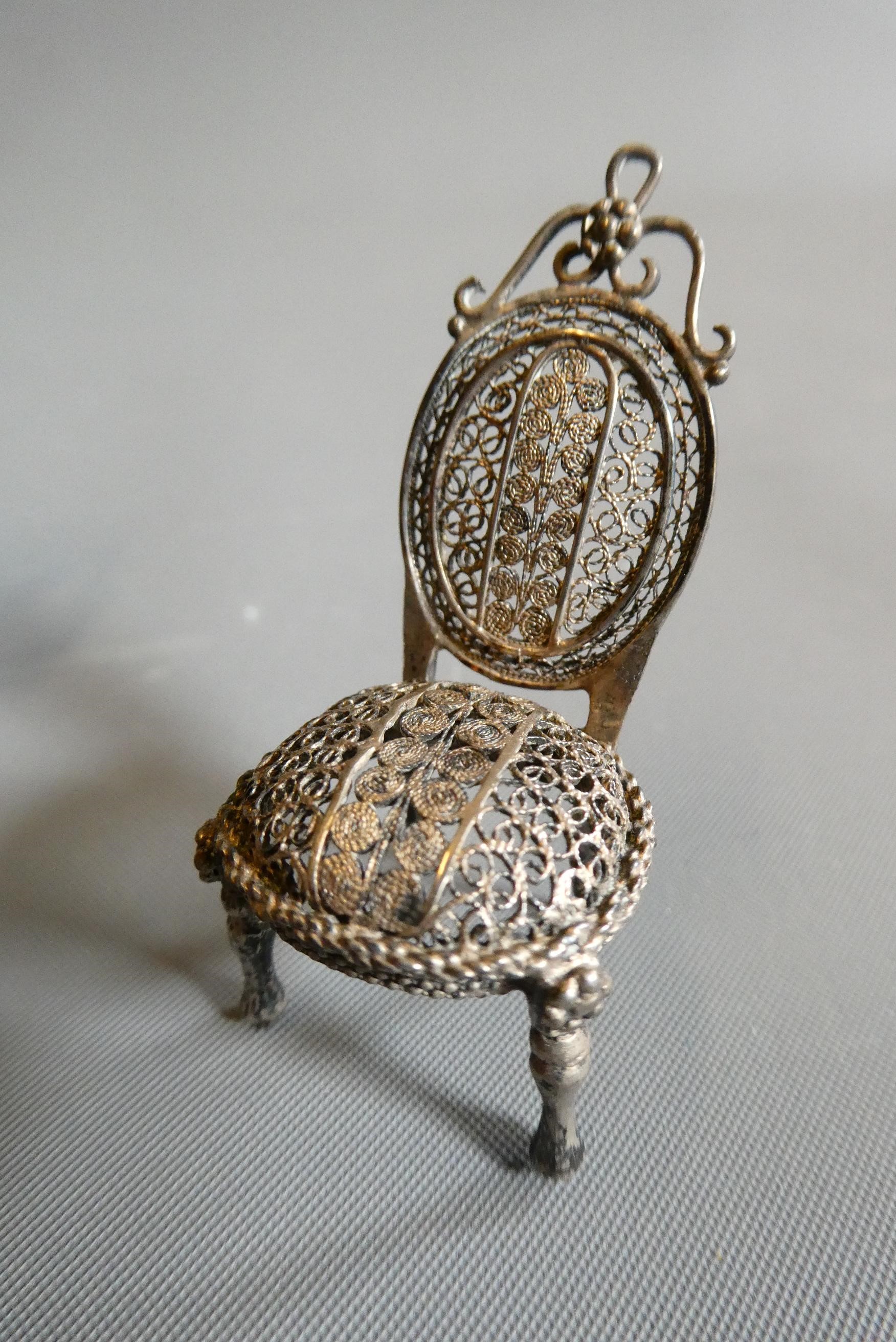 Antique filigree white metal doll's house furniture comprising two chairs, a settee and a pedestal Image