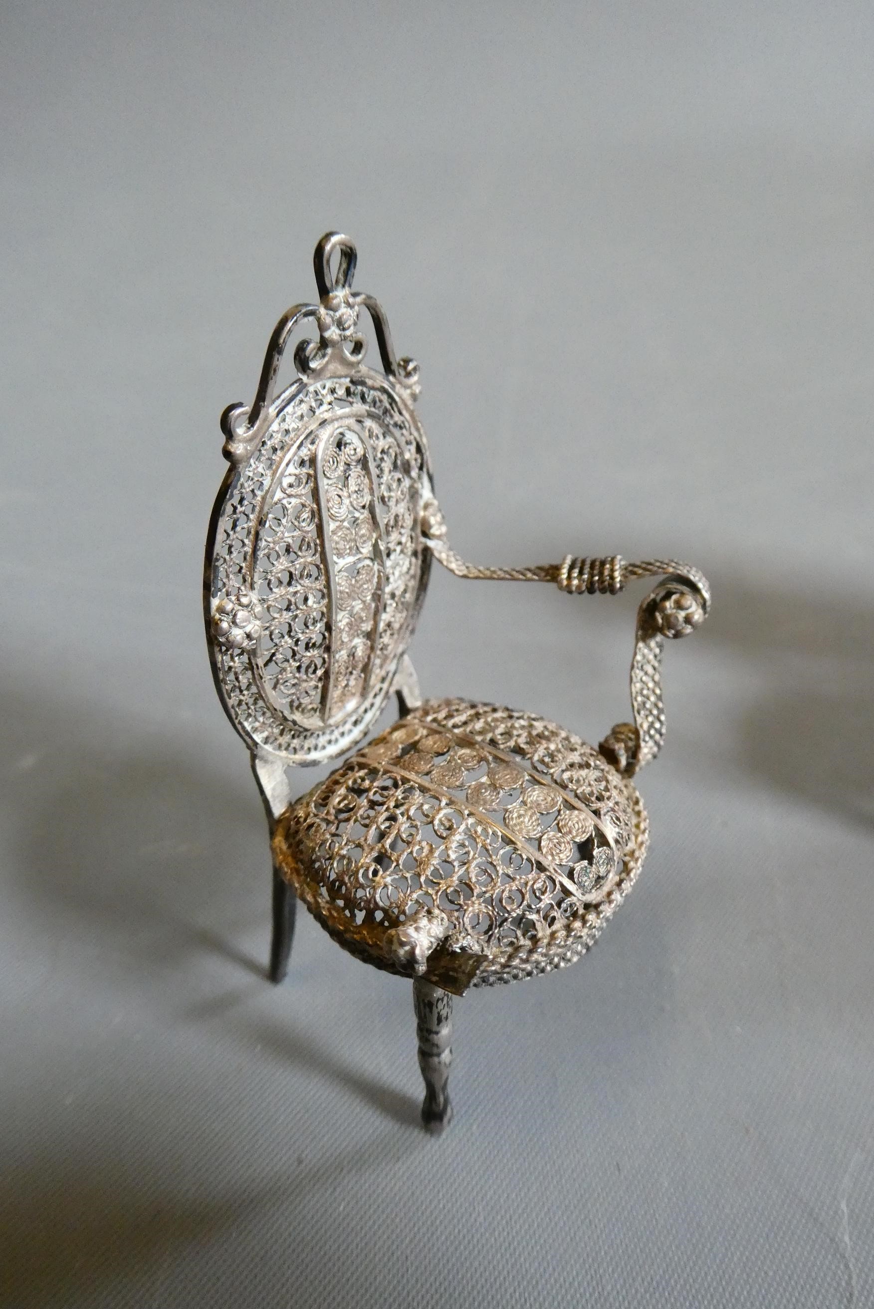 Antique filigree white metal doll's house furniture comprising two chairs, a settee and a pedestal Image