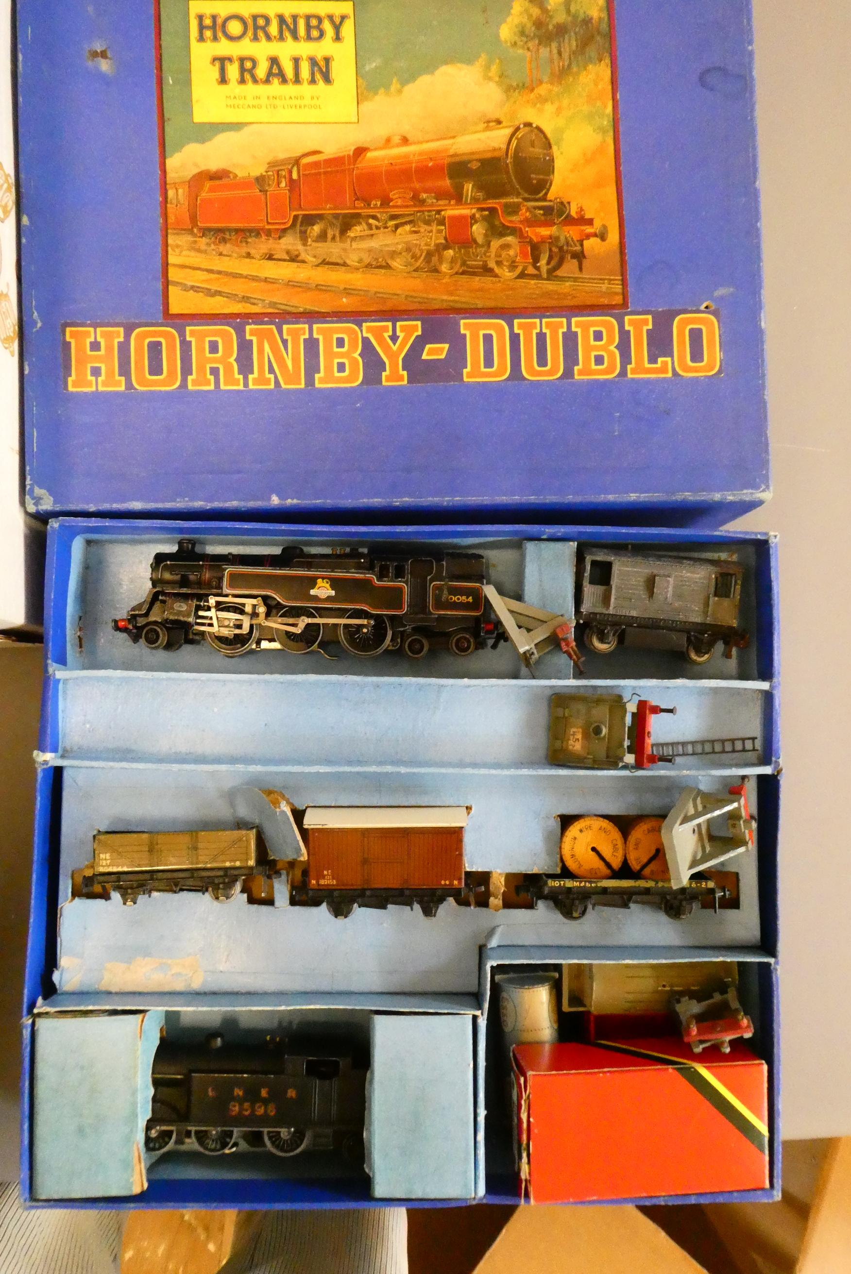 Playworn Hornby Dublo three rail trains including two tank locomotives, goods trucks and trackside Image