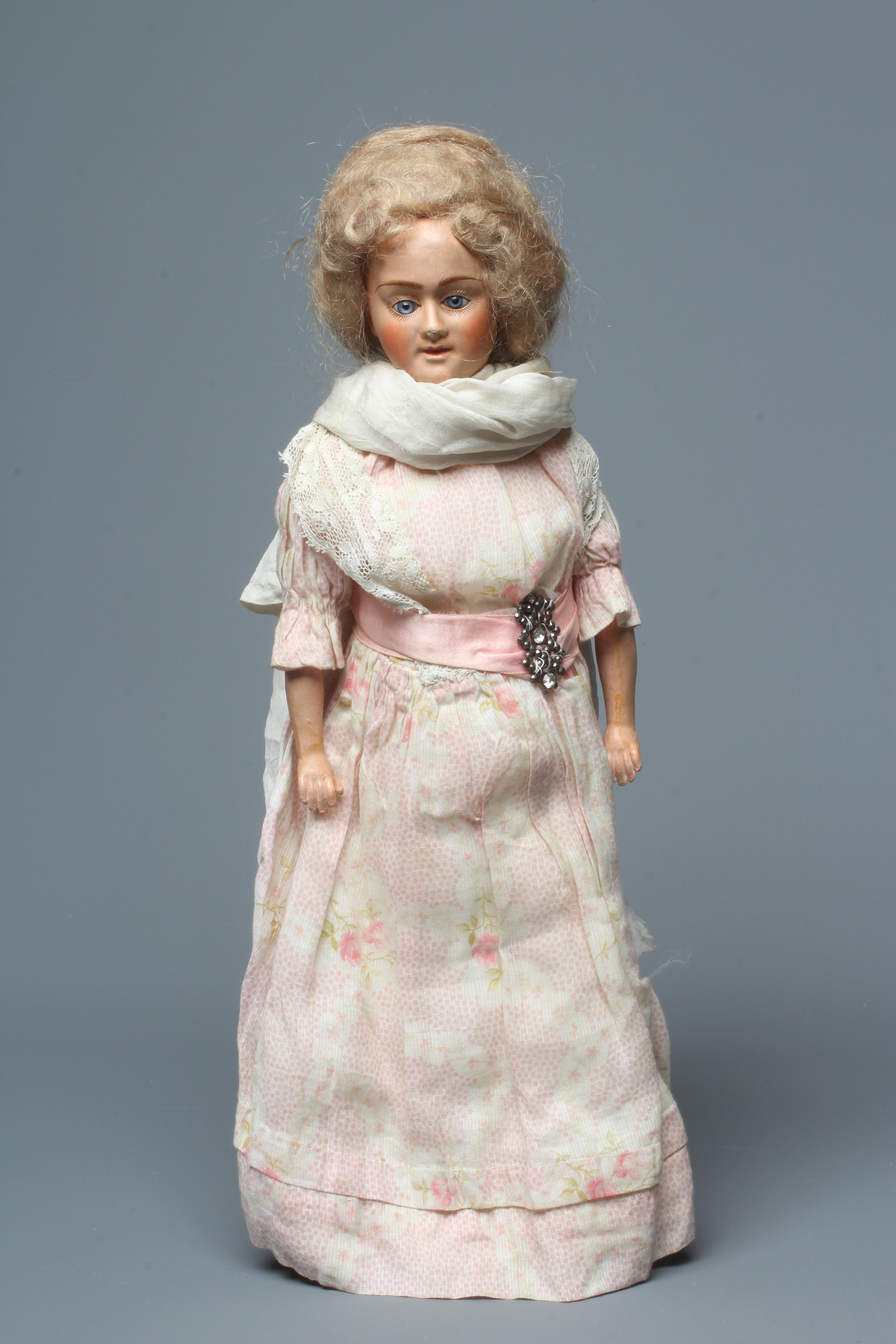 A composite shoulder head doll, circa 1900, with blue glass fixed eyes, closed mouth, blond wig, Image
