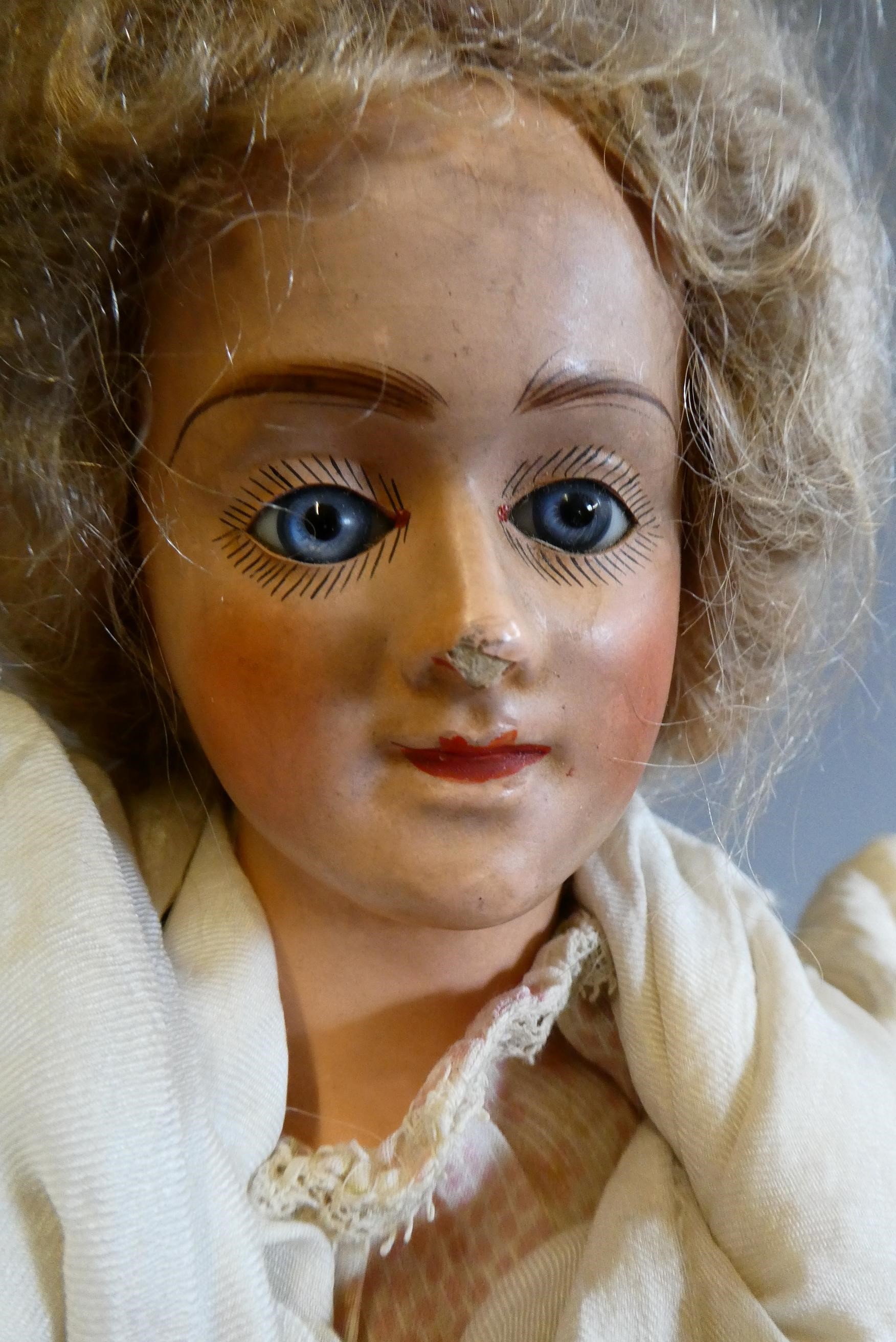 A composite shoulder head doll, circa 1900, with blue glass fixed eyes, closed mouth, blond wig, Image