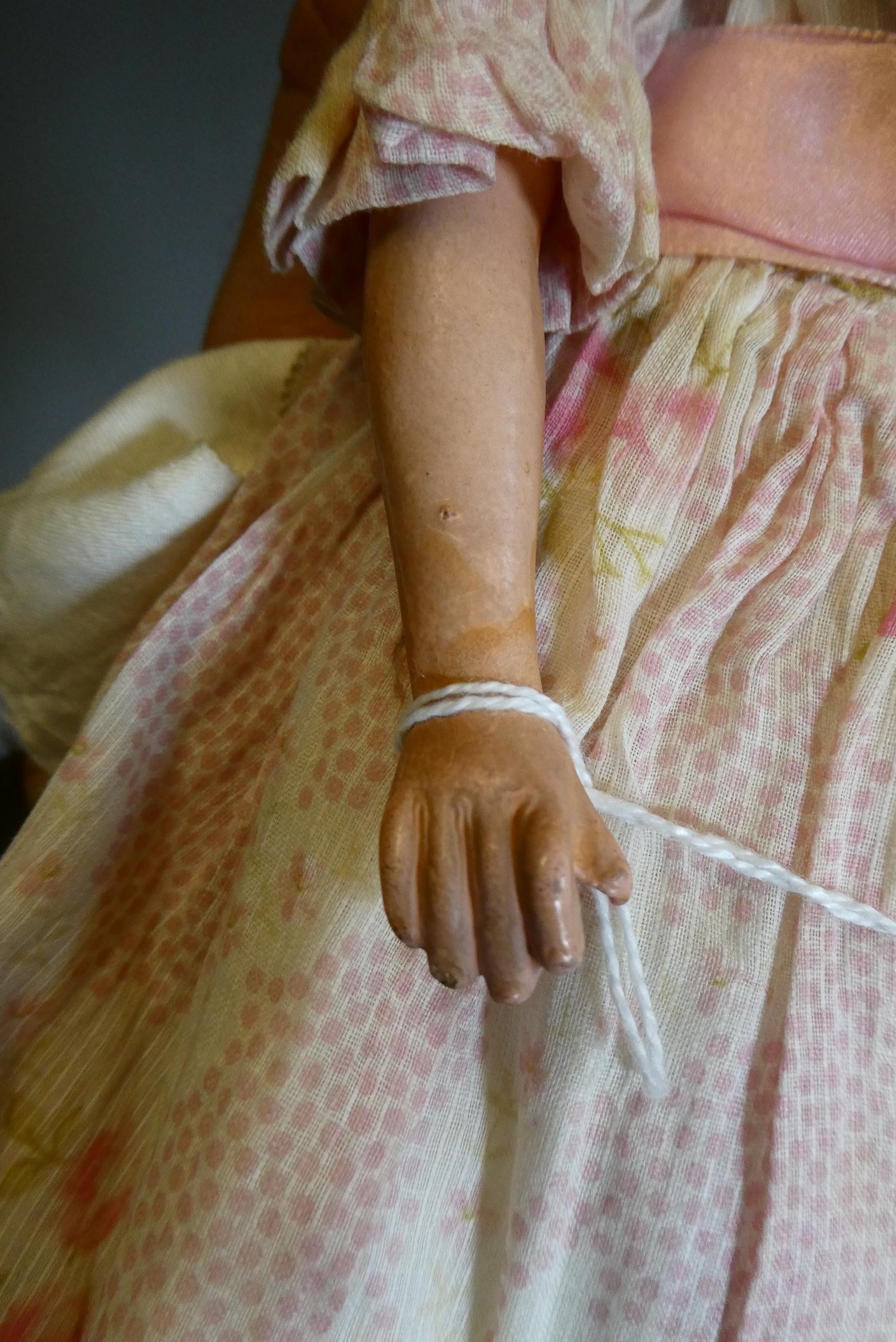 A composite shoulder head doll, circa 1900, with blue glass fixed eyes, closed mouth, blond wig, Image