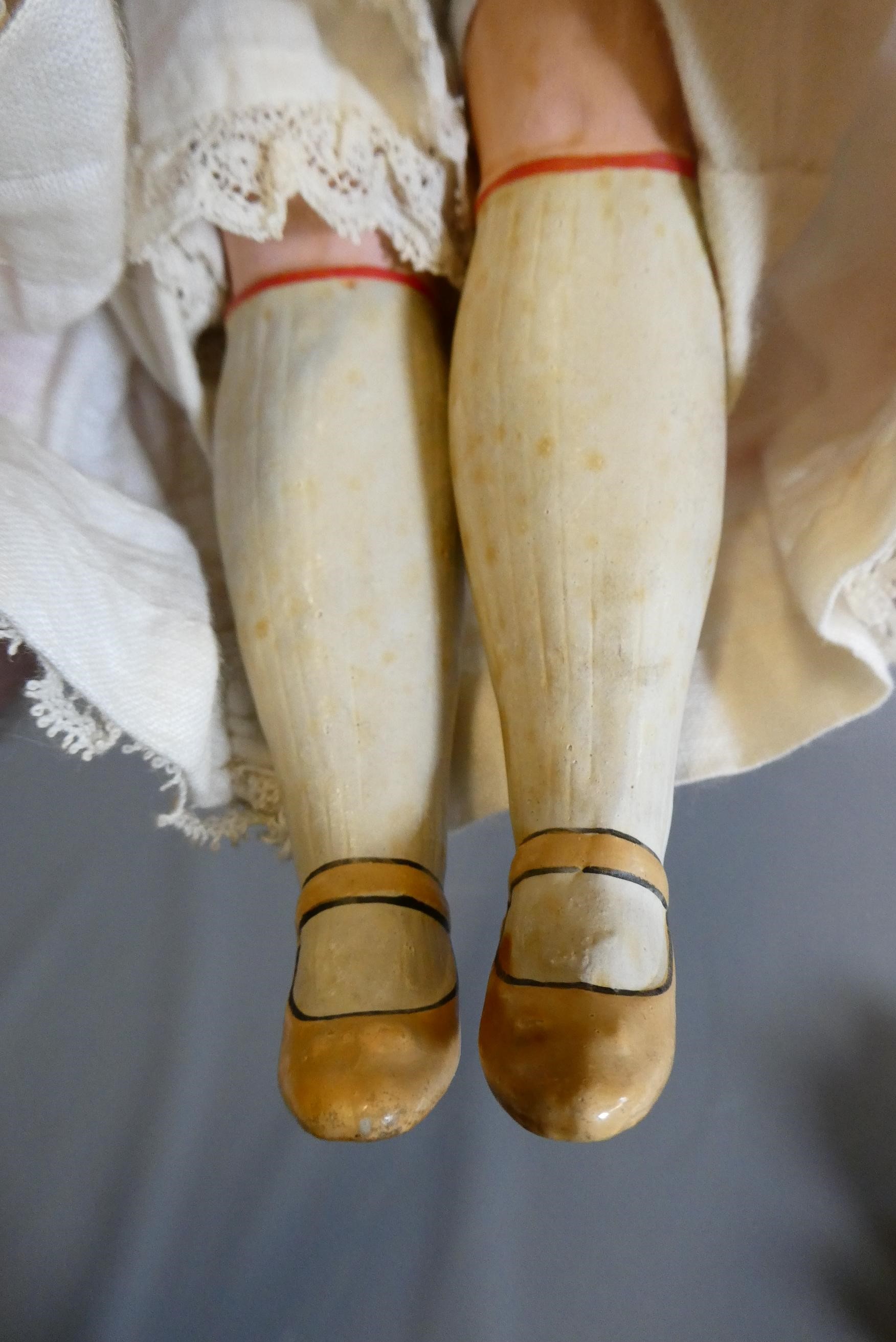 A composite shoulder head doll, circa 1900, with blue glass fixed eyes, closed mouth, blond wig, Image