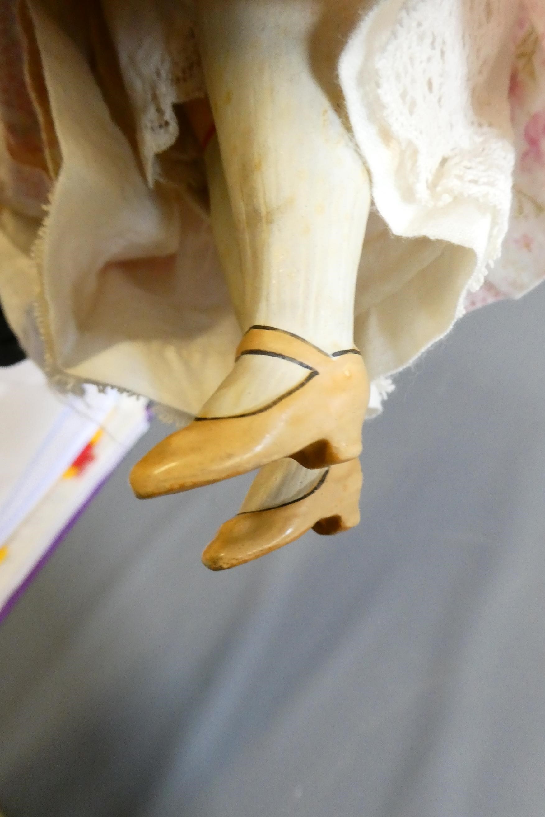 A composite shoulder head doll, circa 1900, with blue glass fixed eyes, closed mouth, blond wig, Image