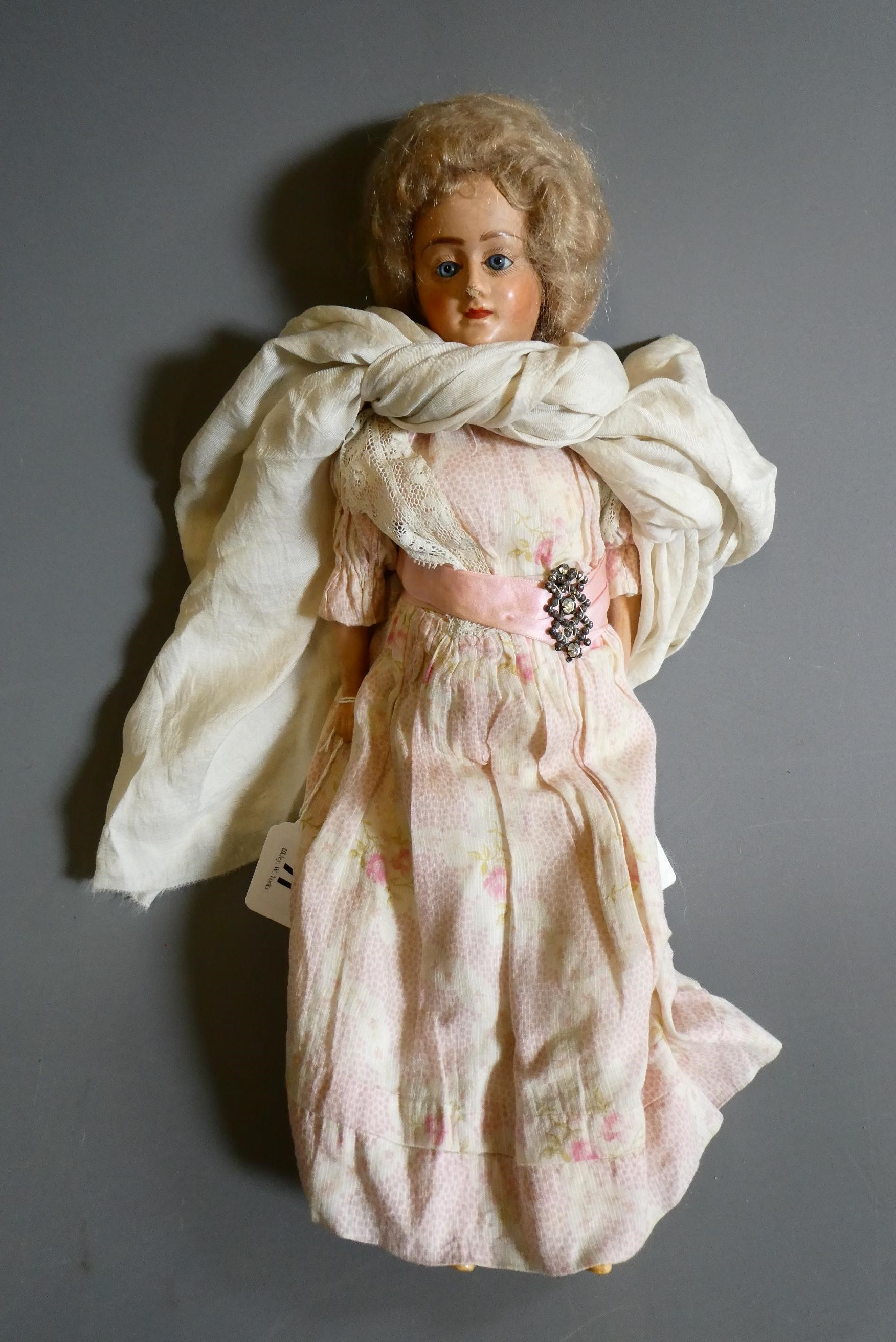 A composite shoulder head doll, circa 1900, with blue glass fixed eyes, closed mouth, blond wig, Image
