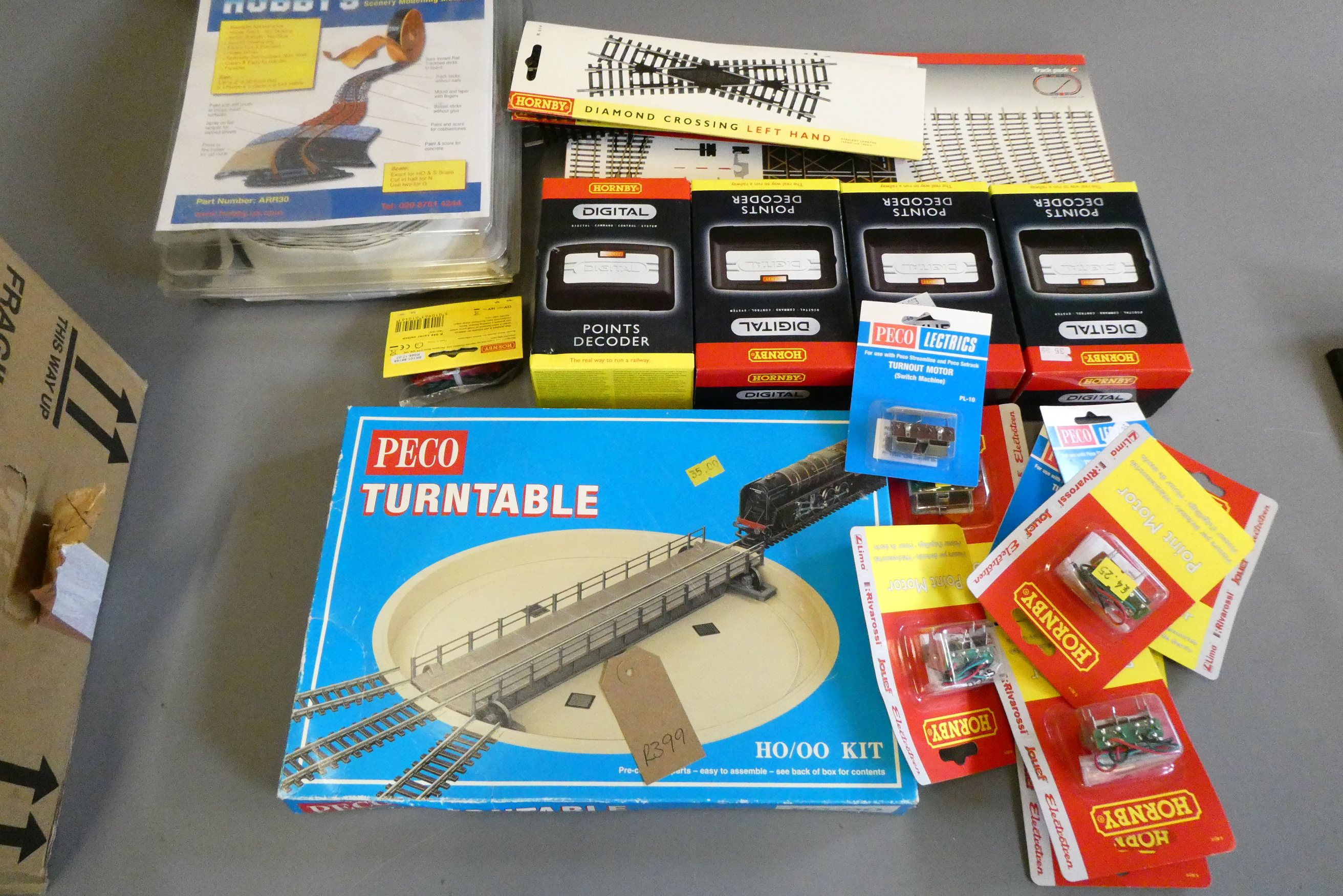 Four Hornby DCC point decoders, sub base board point motors, track and scenic materials, most items Image