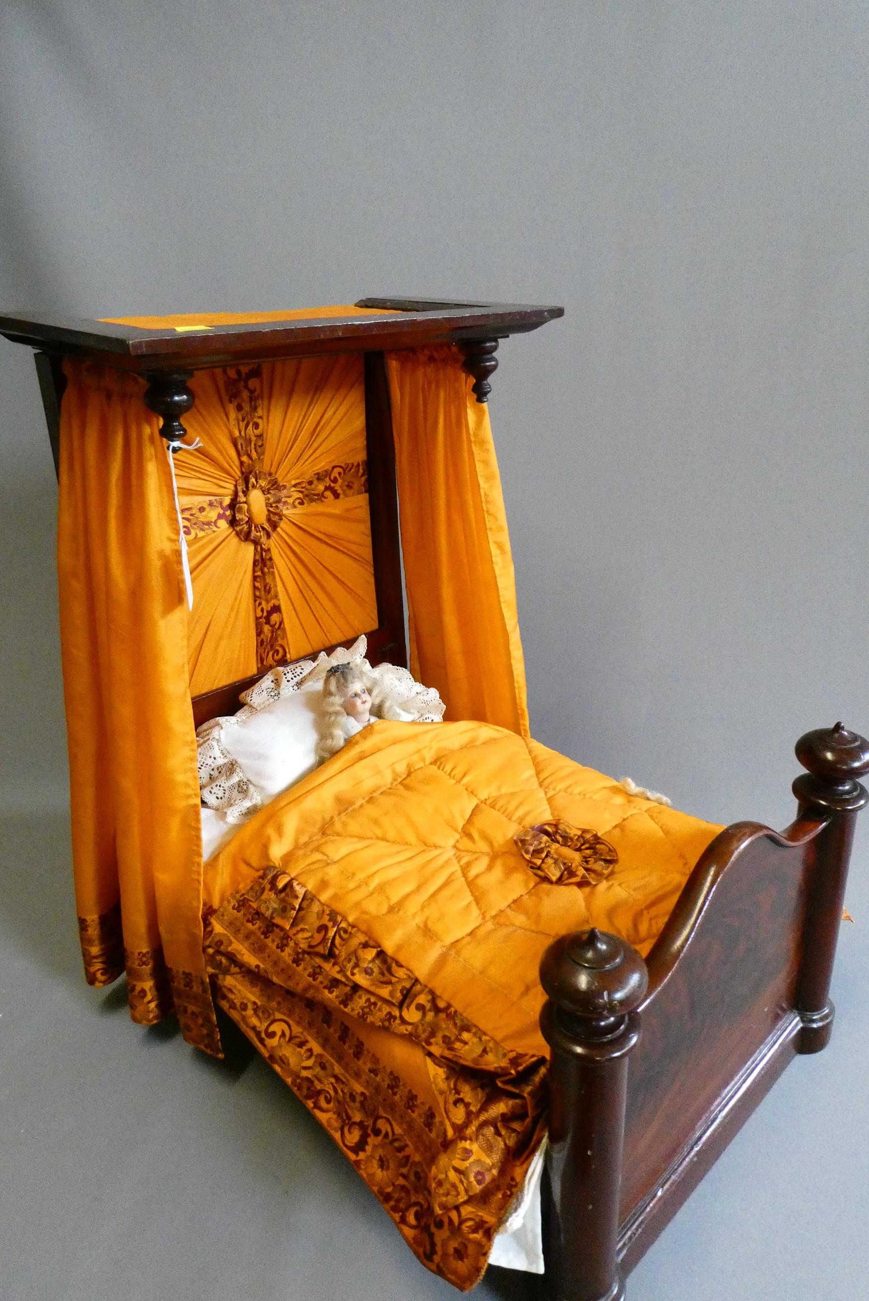 A mahogany half tester doll's bed Image
