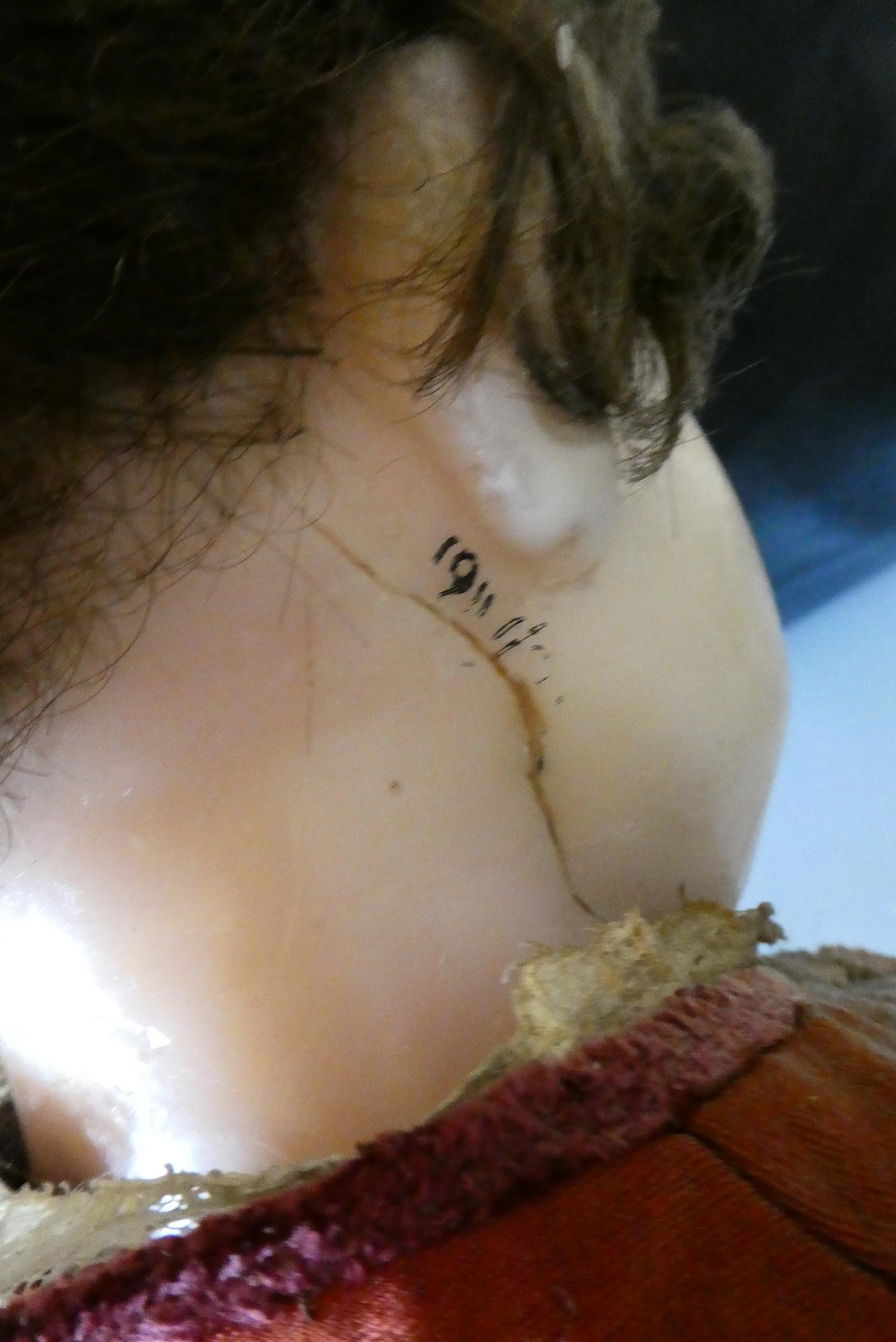 A Victorian wax shoulder head doll Image