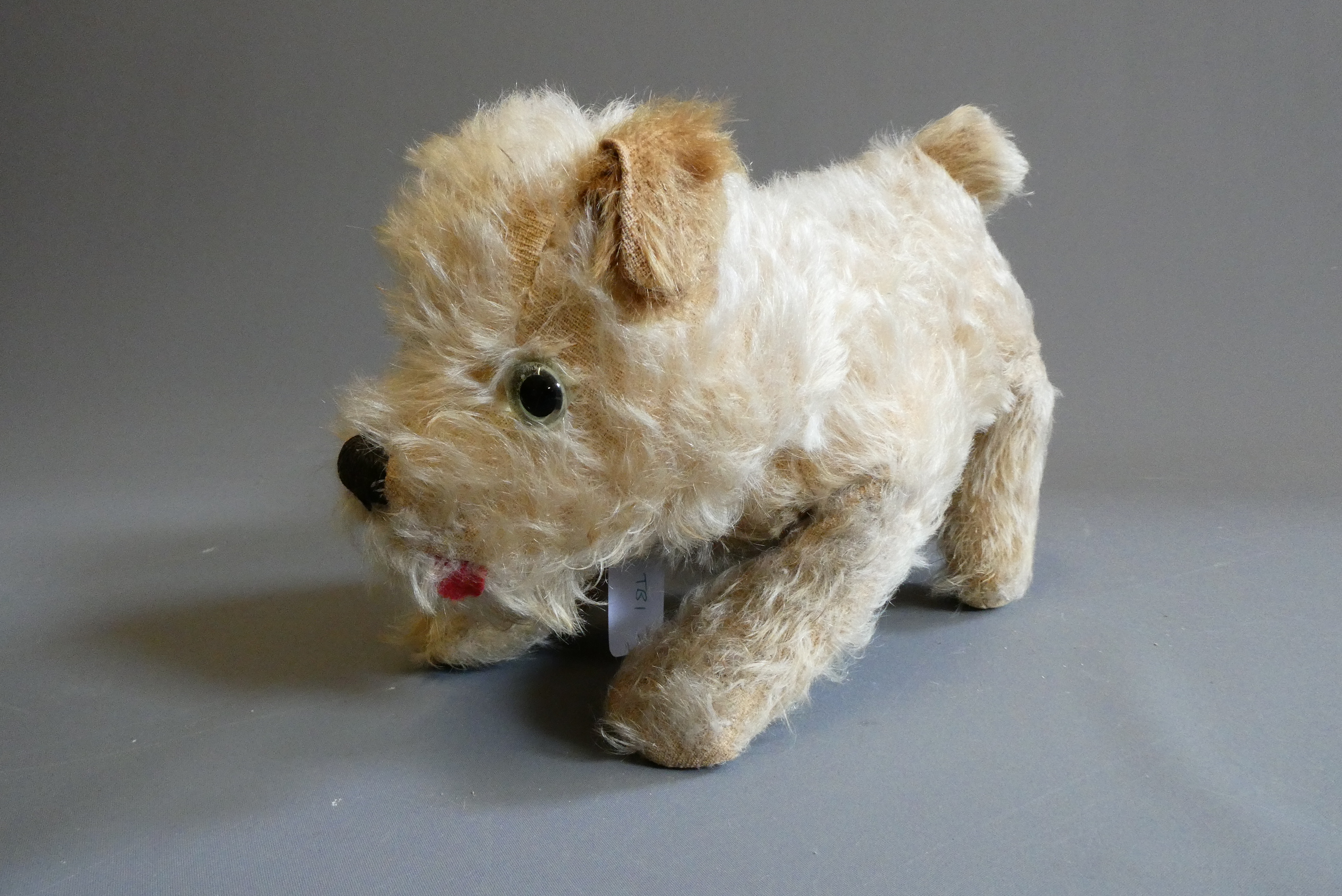 Farnell Alpha Toy dog, with clear glass eyes, sewn nose, felt tongue and maker's label, 11 1/2" long Image