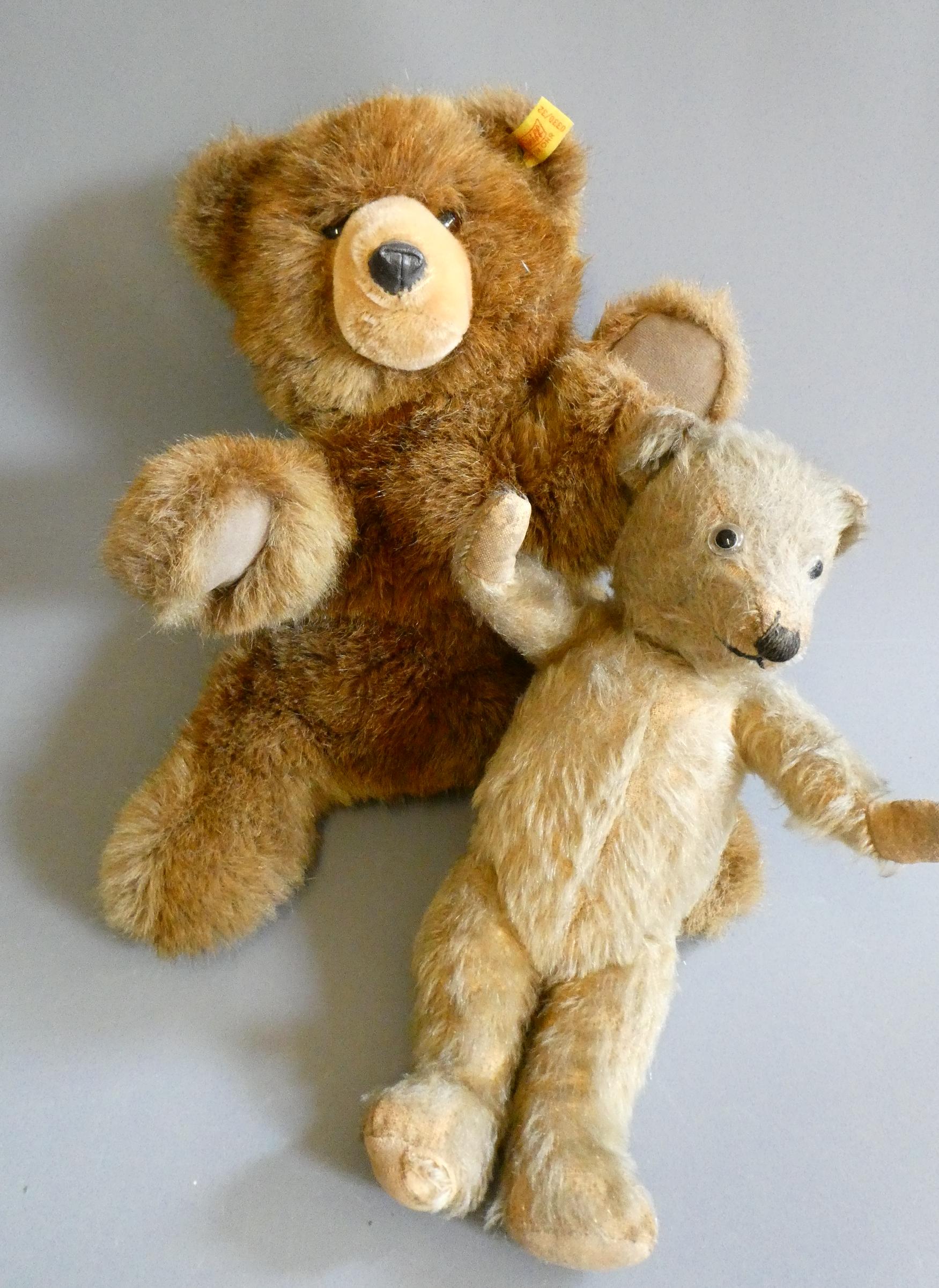 Two teddy bears, comprising an old 12" English bear, with clear glass eyes, sewn nose and light Image