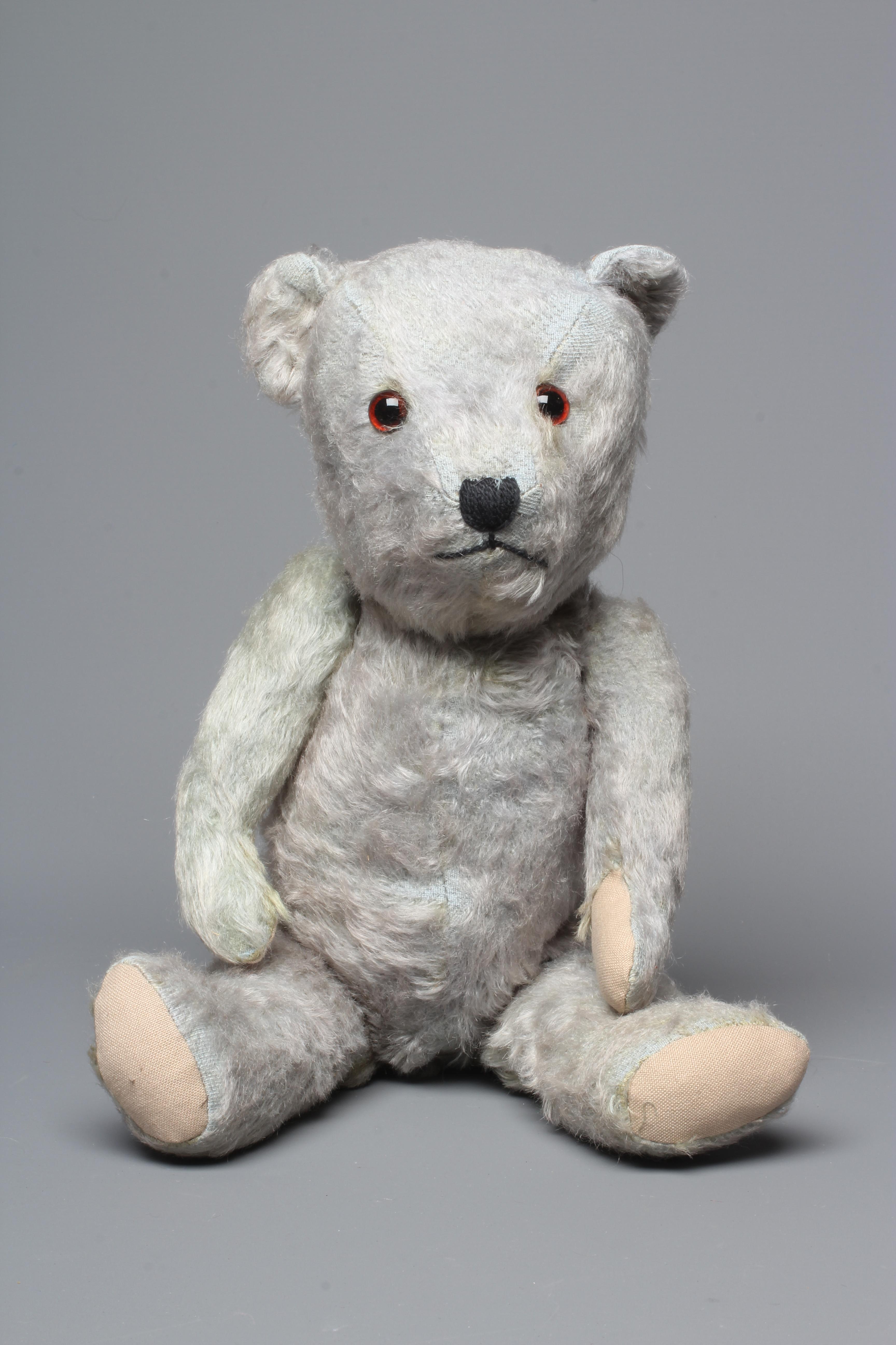 A rare blue Hugmee Chiltern teddy bear "bluey", with amber glass eyes, sewn nose and fabric pads, Image