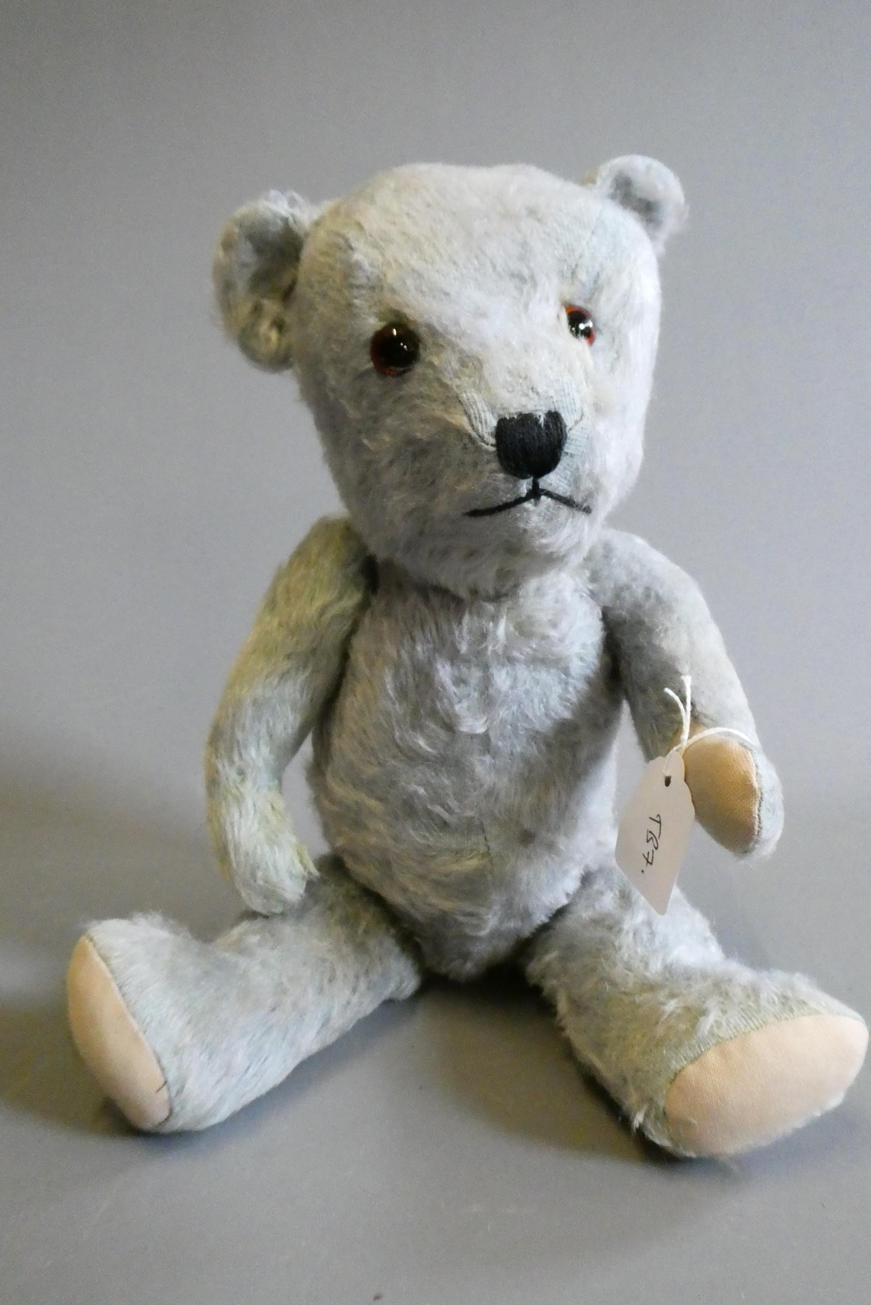 A rare blue Hugmee Chiltern teddy bear "bluey", with amber glass eyes, sewn nose and fabric pads, Image