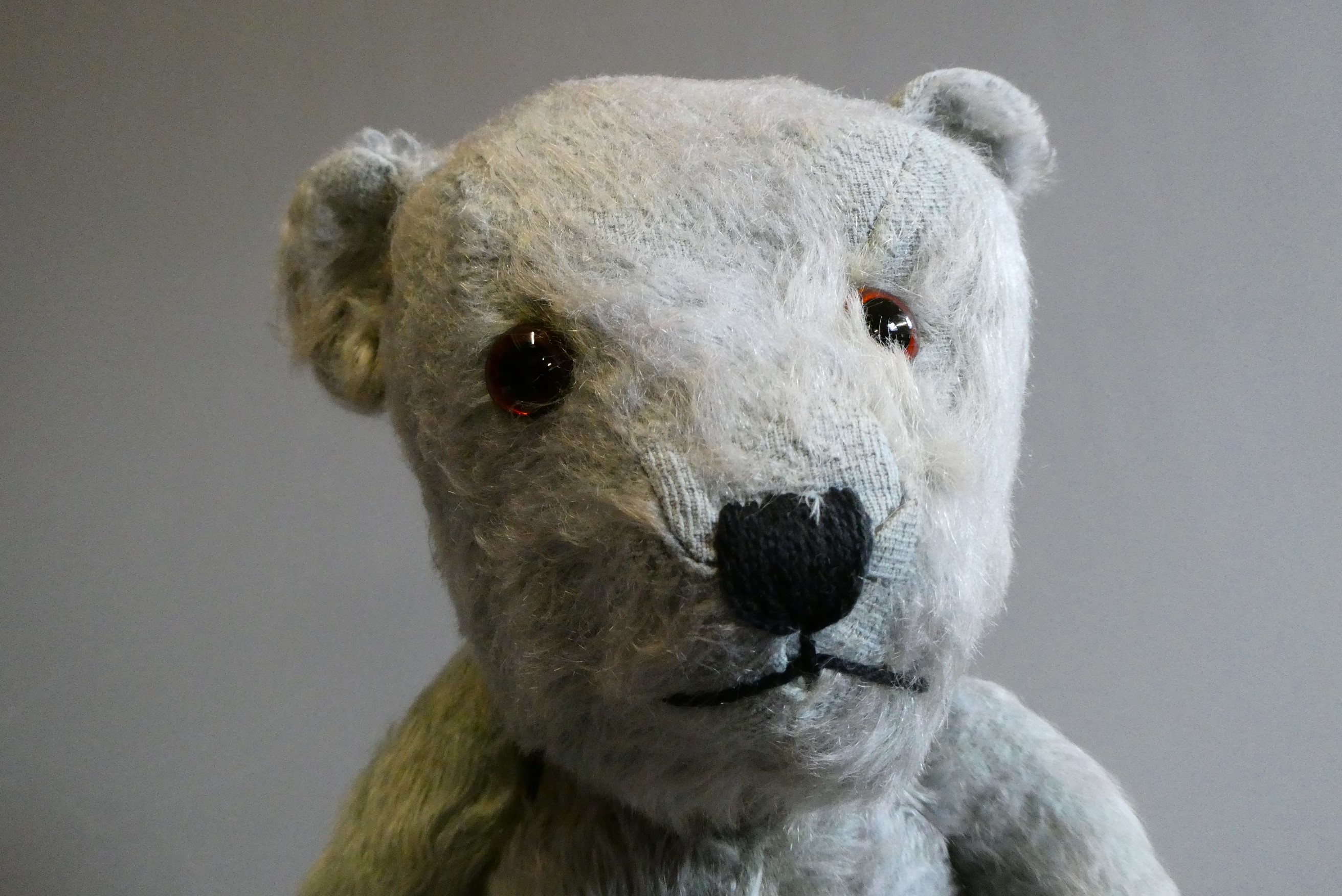 A rare blue Hugmee Chiltern teddy bear "bluey", with amber glass eyes, sewn nose and fabric pads, Image