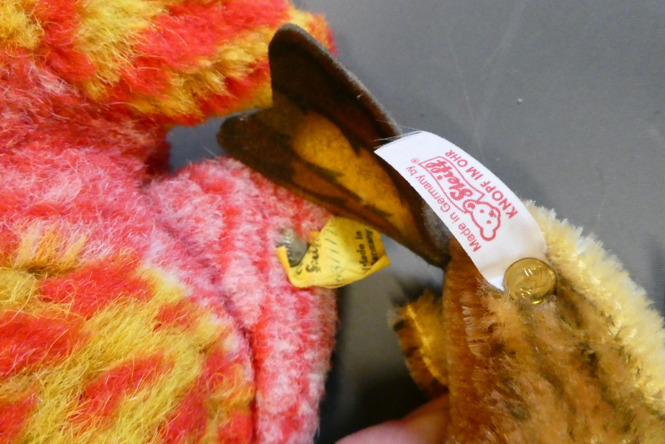 Two vintage Steiff plush toys, comprising a 7" fish and a 5 1/4" bird, both with labels and buttons Image