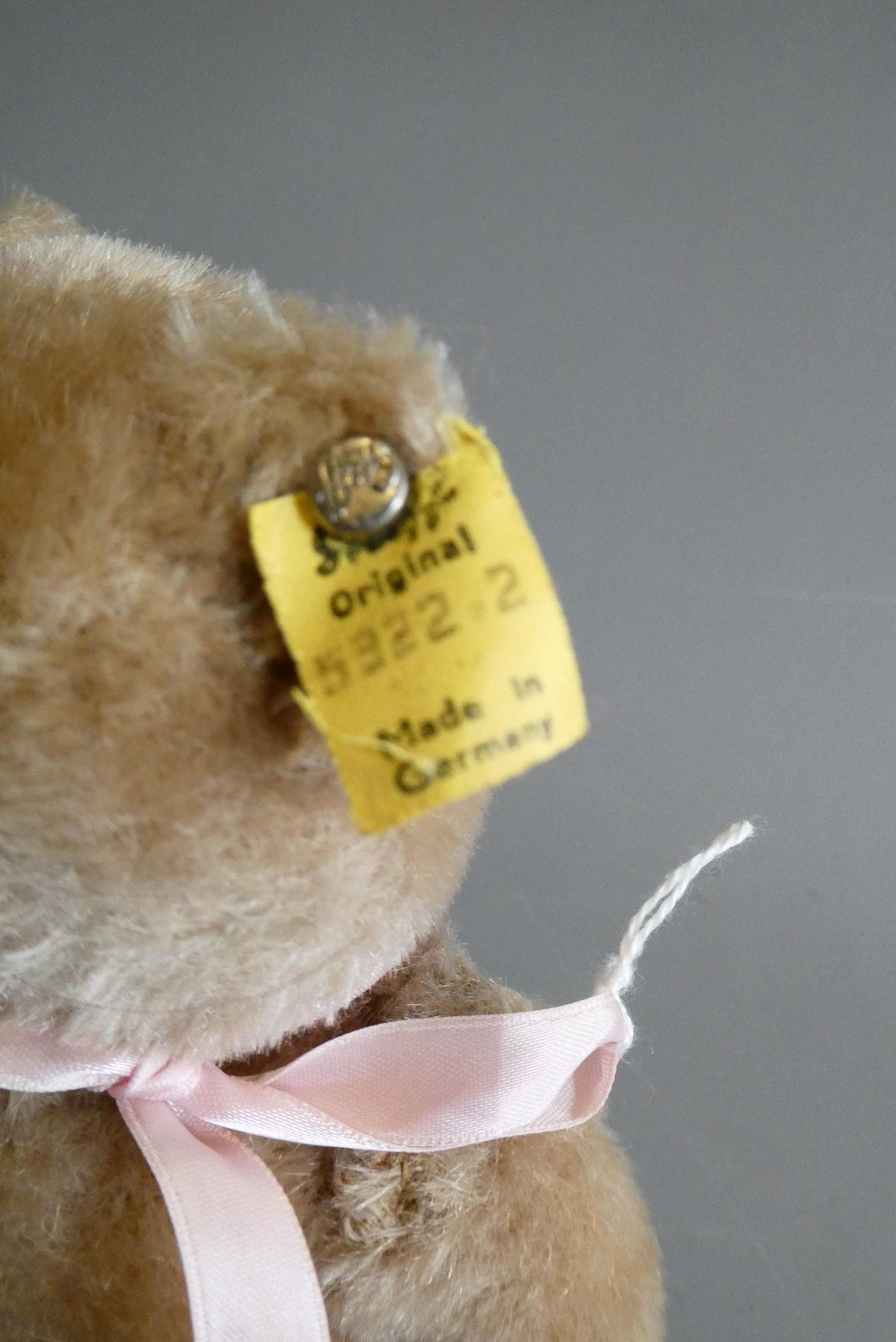 A pair of 1950s Steiff teddy bears, both with amber glass eyes, sewn noses, felt pads and ears with Image