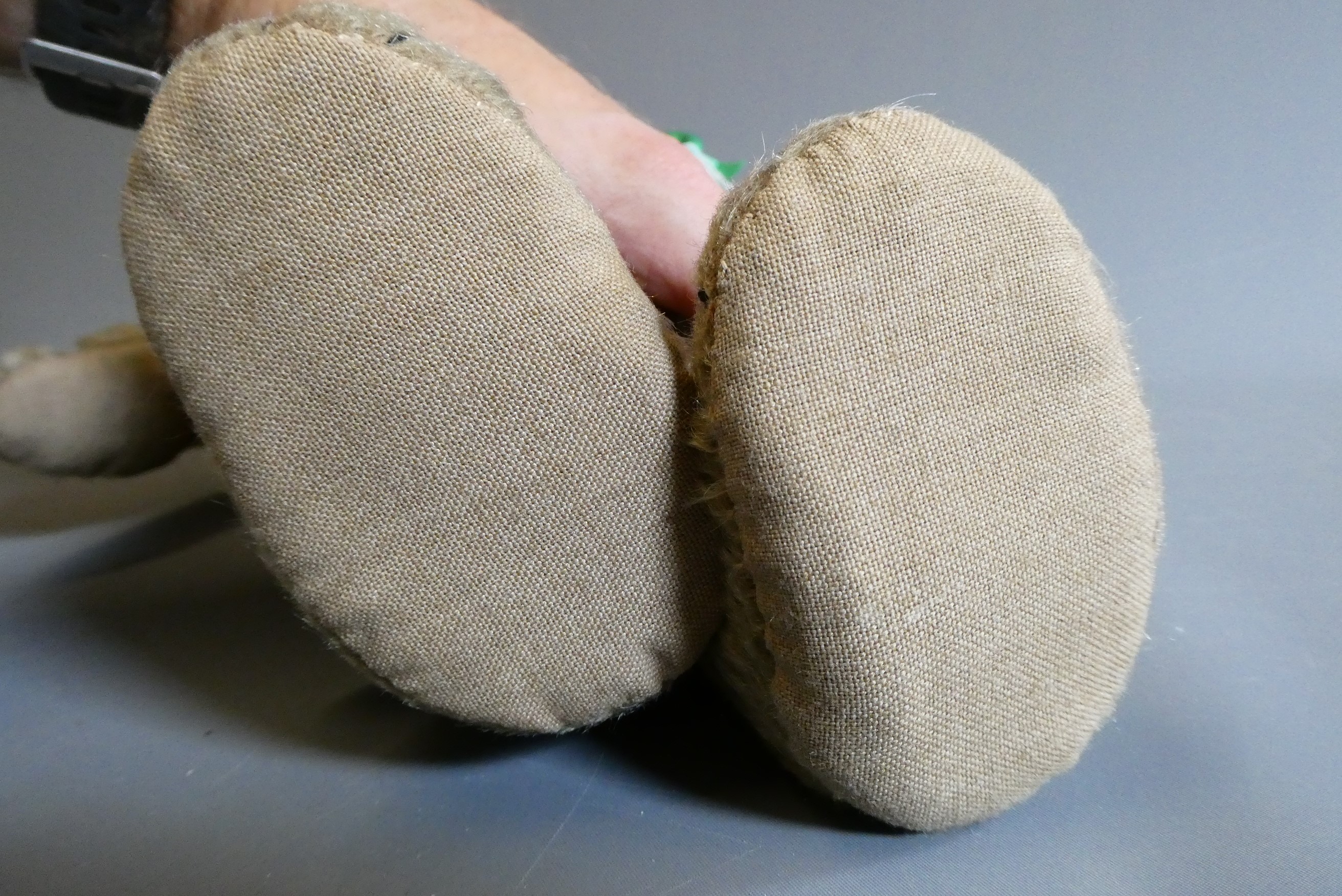 A pre-war shoe button eye teddy bear, with sewn nose, brown plush, bell to neck, jointed shoulders Image