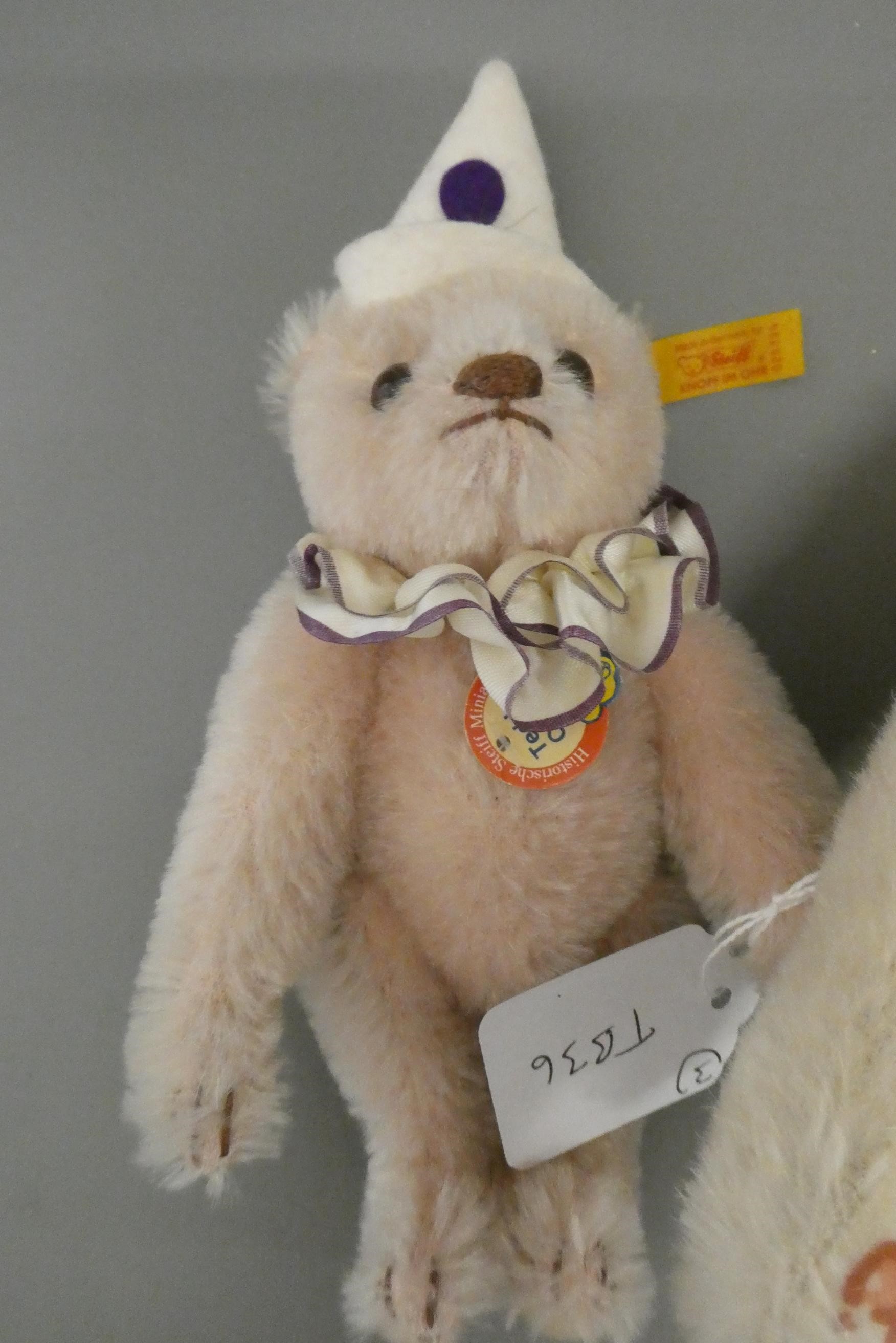 Three Steiff teddy bears, comprising a 12 1/2" white bear, a 6 3/4" red bear and a 7 3/4" teddy Image