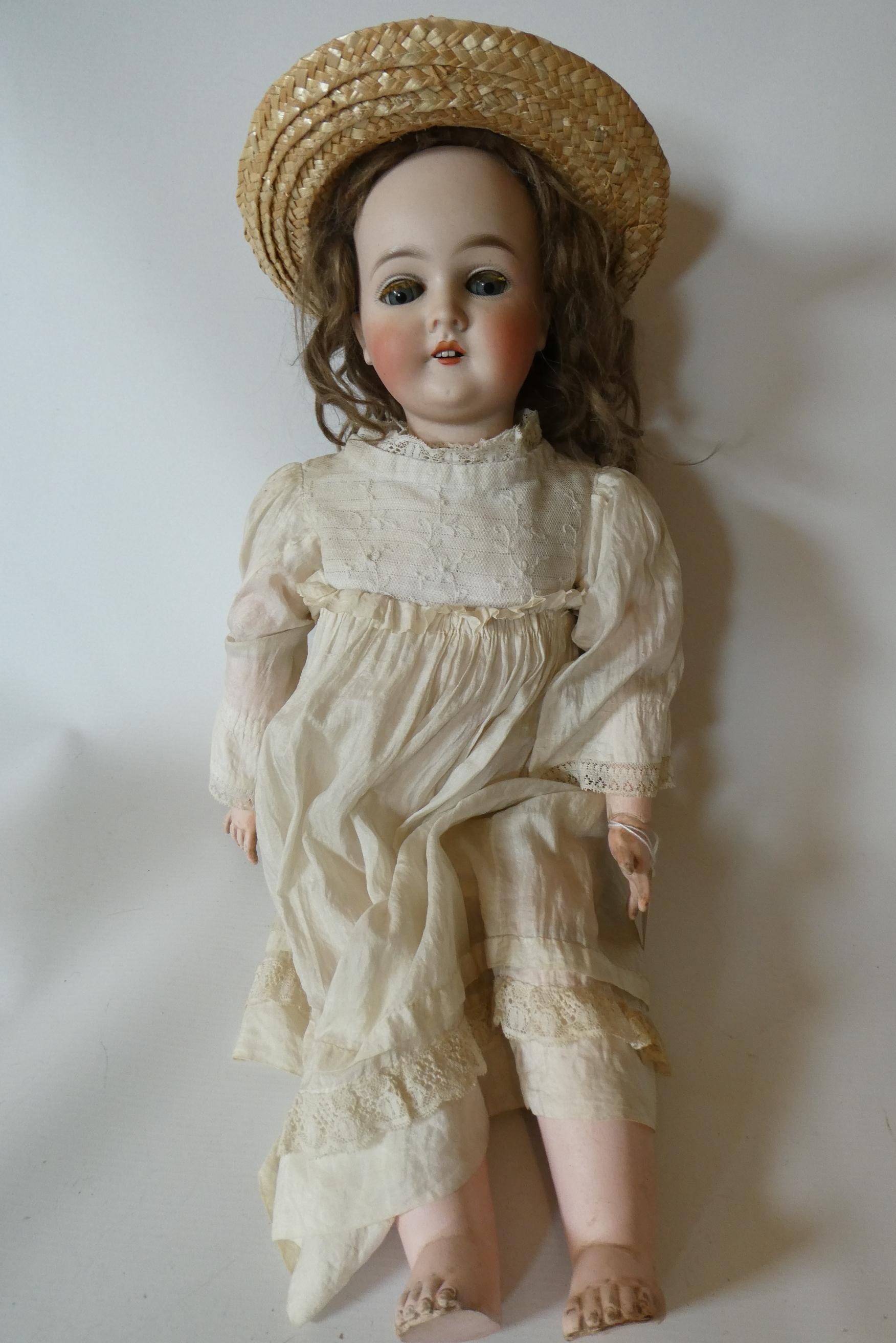 A Queen Louise bisque socket head doll with blue glass sleeping eyes Image