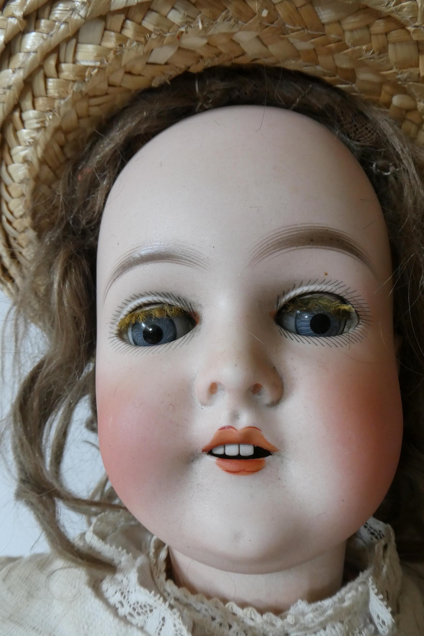 A Queen Louise bisque socket head doll with blue glass sleeping eyes Image