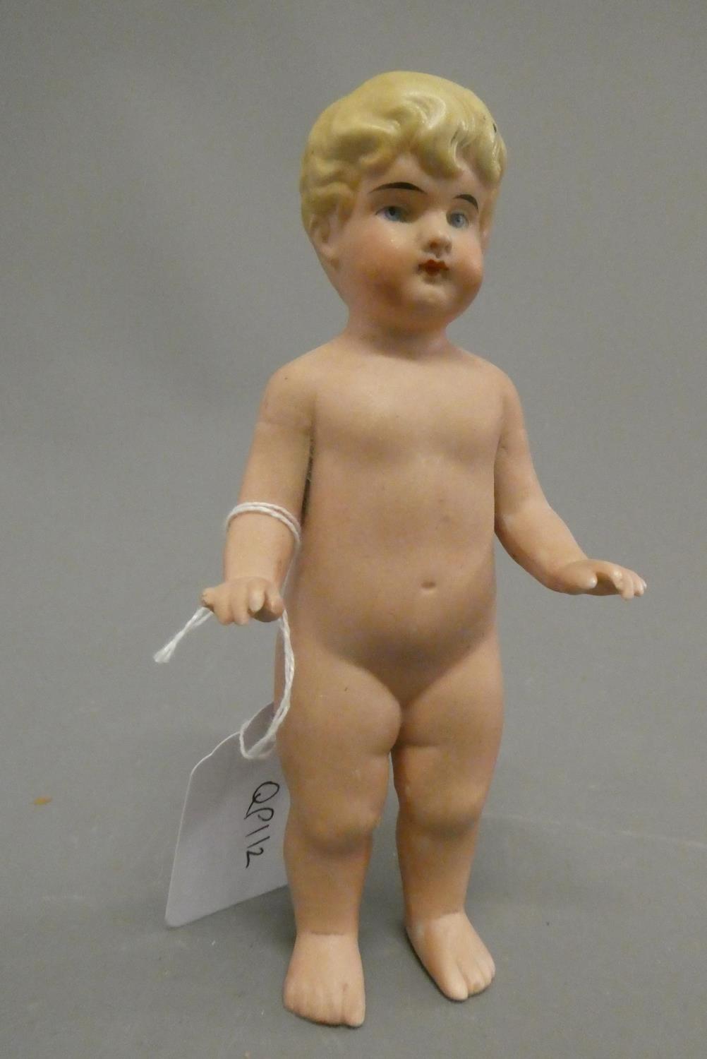 An all bisque frozen Charlotte doll, with blond moulded hair, painted features and bent arms, 5 3/4" Image