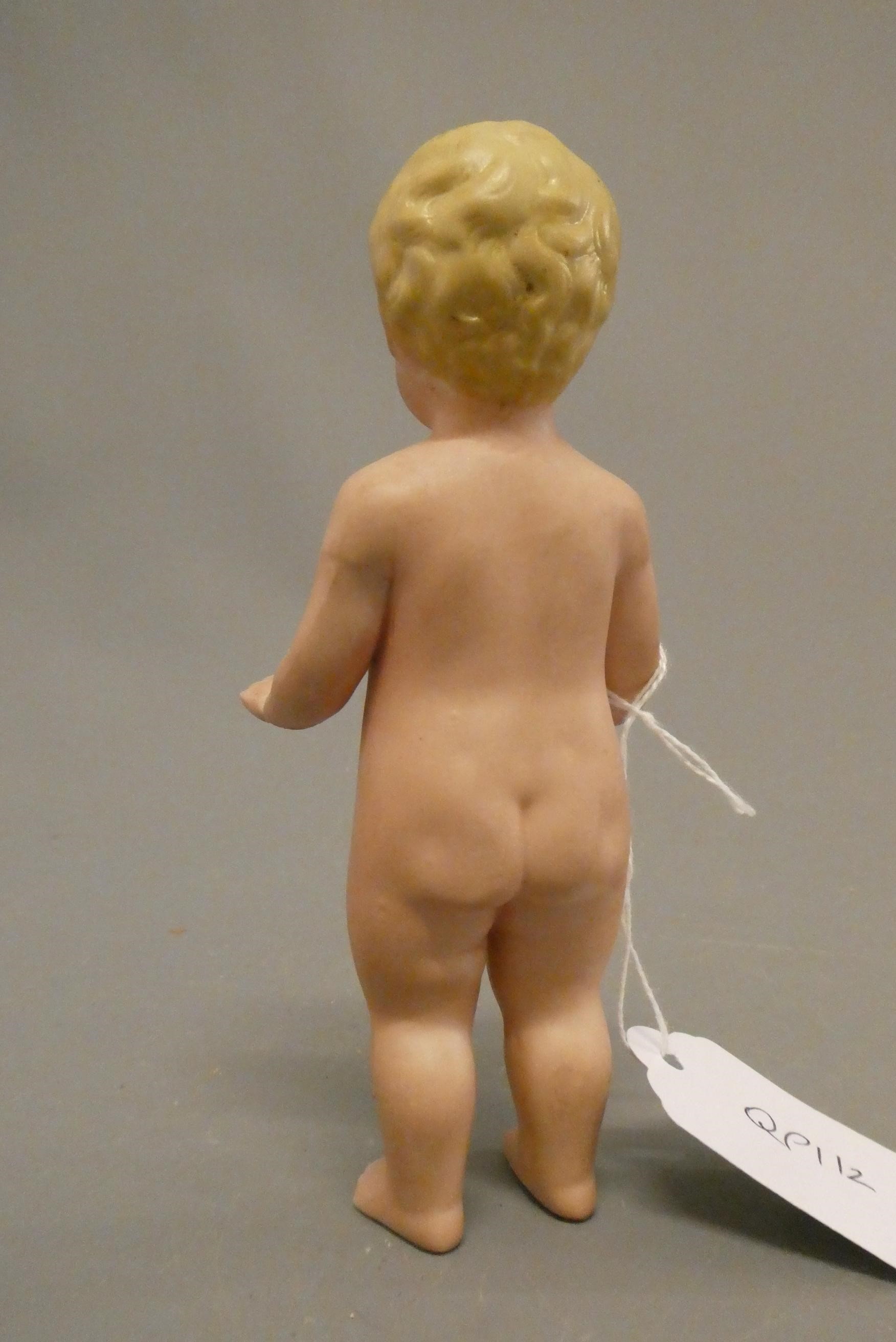 An all bisque frozen Charlotte doll, with blond moulded hair, painted features and bent arms, 5 3/4" Image