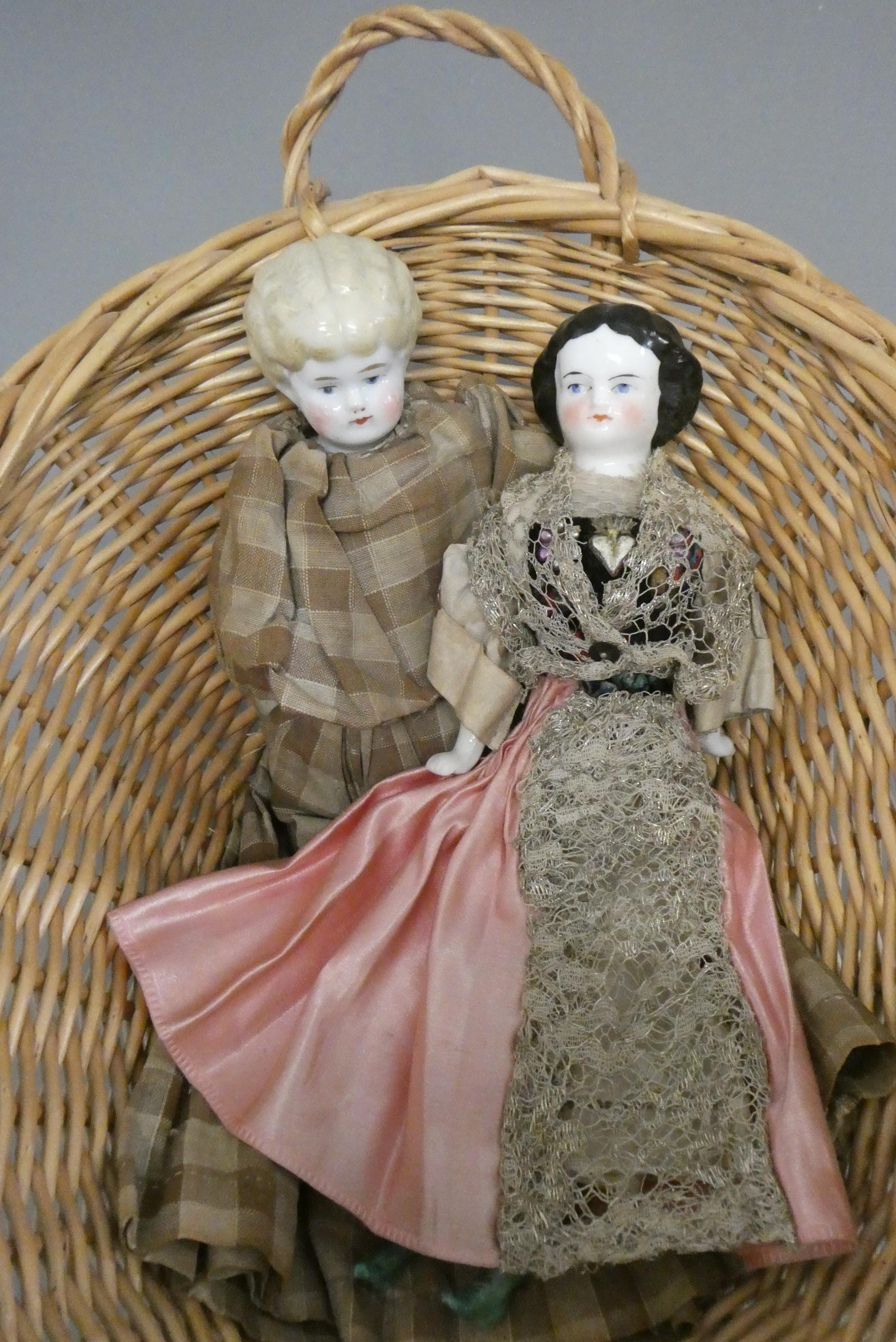 Two antique china shoulder head dolls, with moulded hair, painted features, fabric bodies, bisque Image