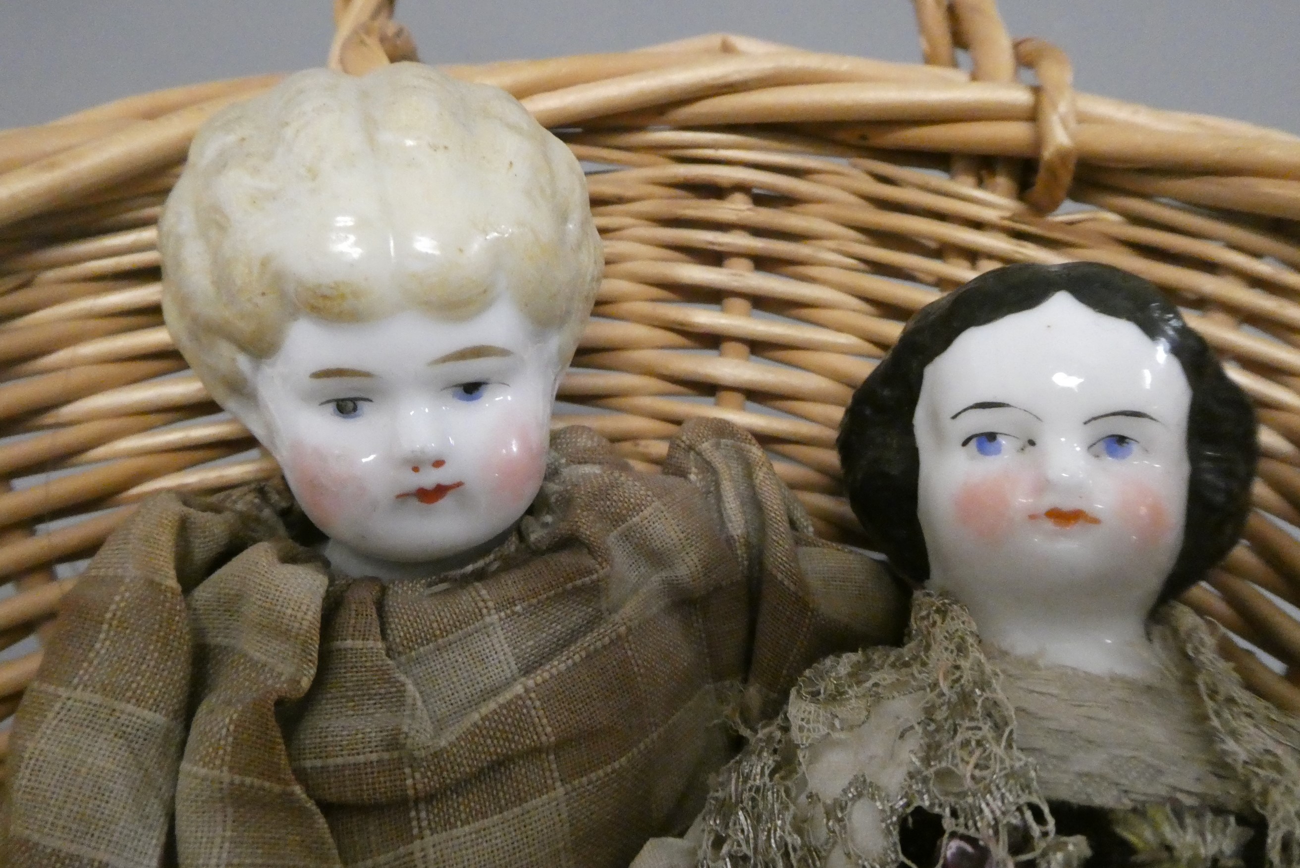 Two antique china shoulder head dolls, with moulded hair, painted features, fabric bodies, bisque Image
