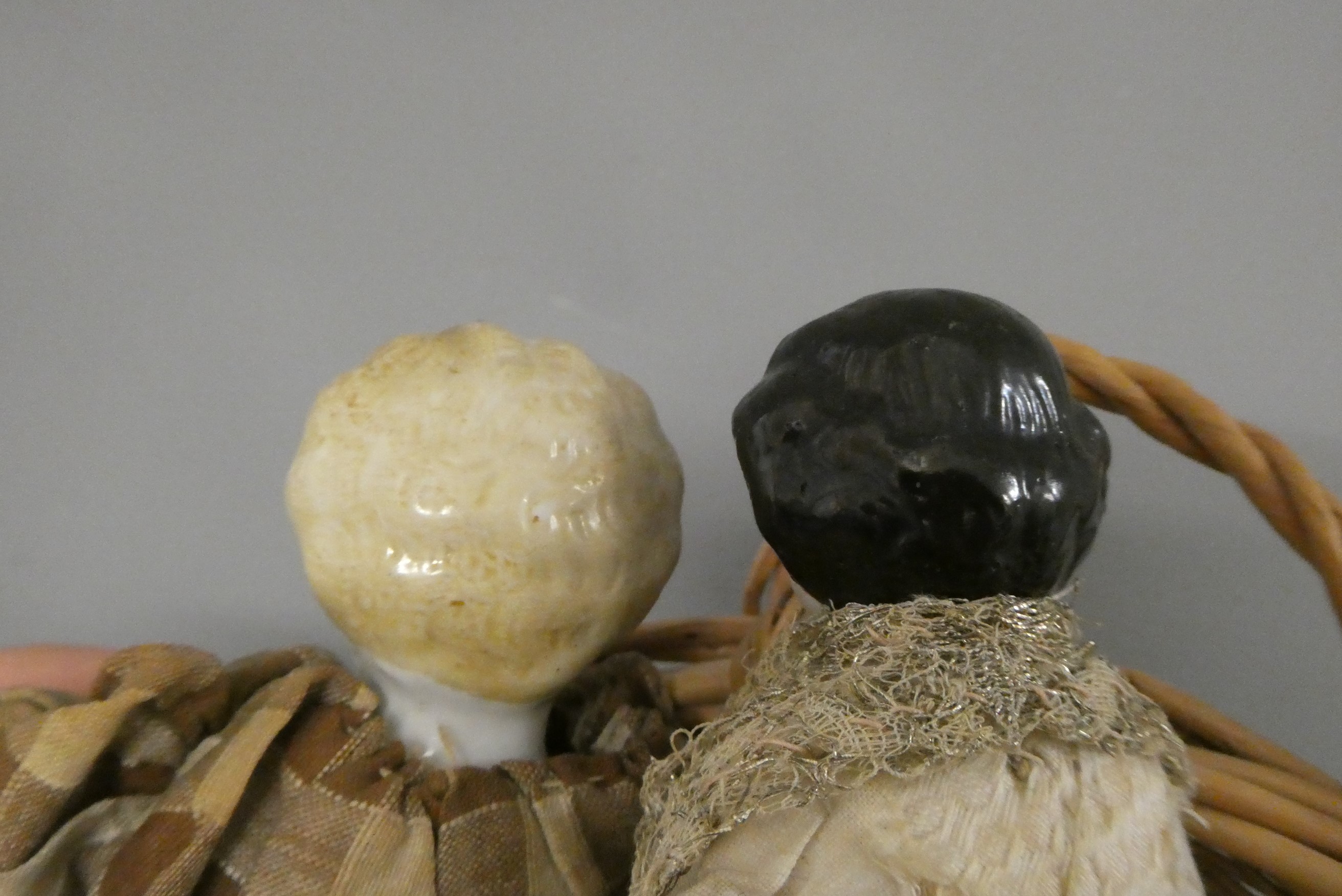 Two antique china shoulder head dolls, with moulded hair, painted features, fabric bodies, bisque Image