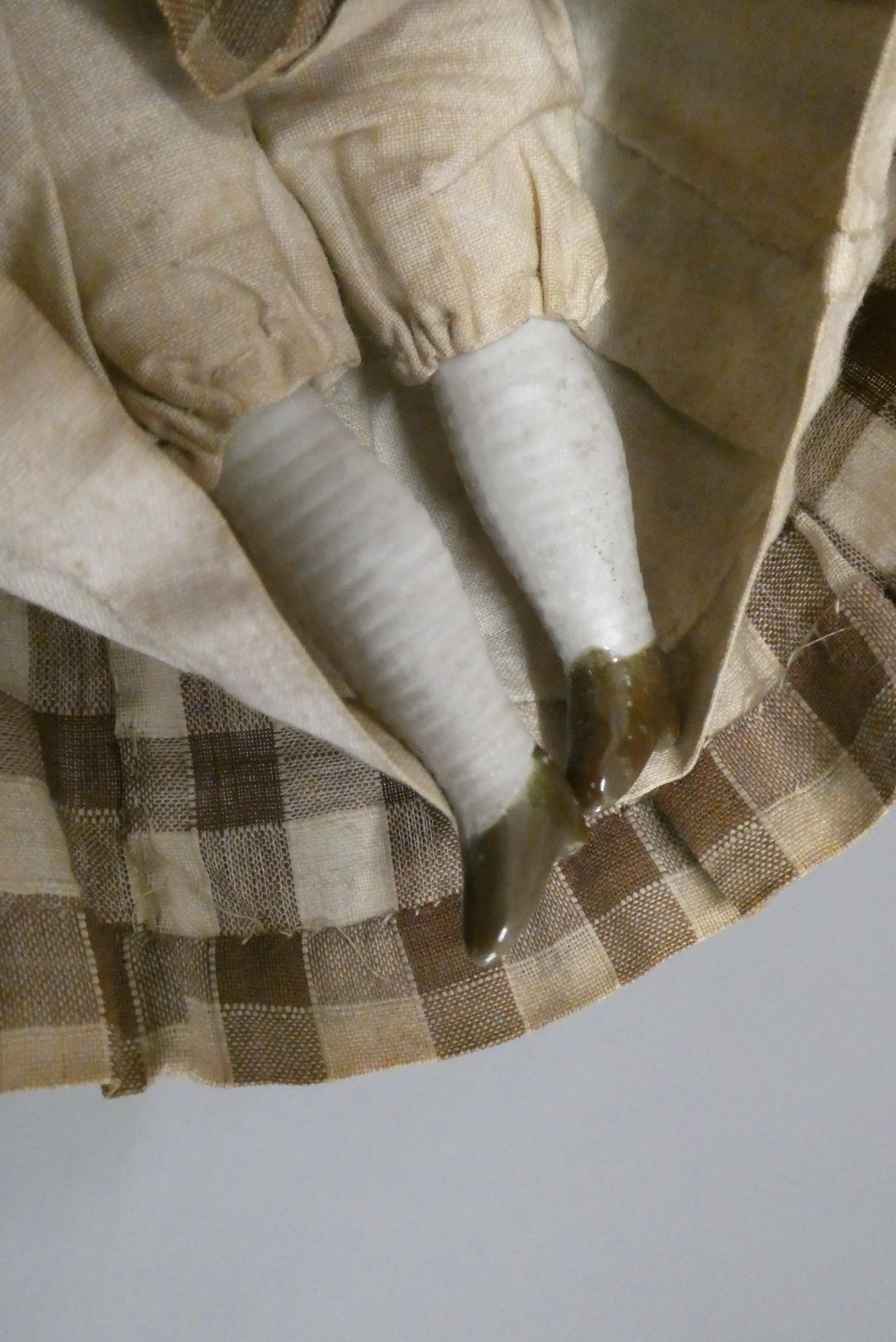 Two antique china shoulder head dolls, with moulded hair, painted features, fabric bodies, bisque Image