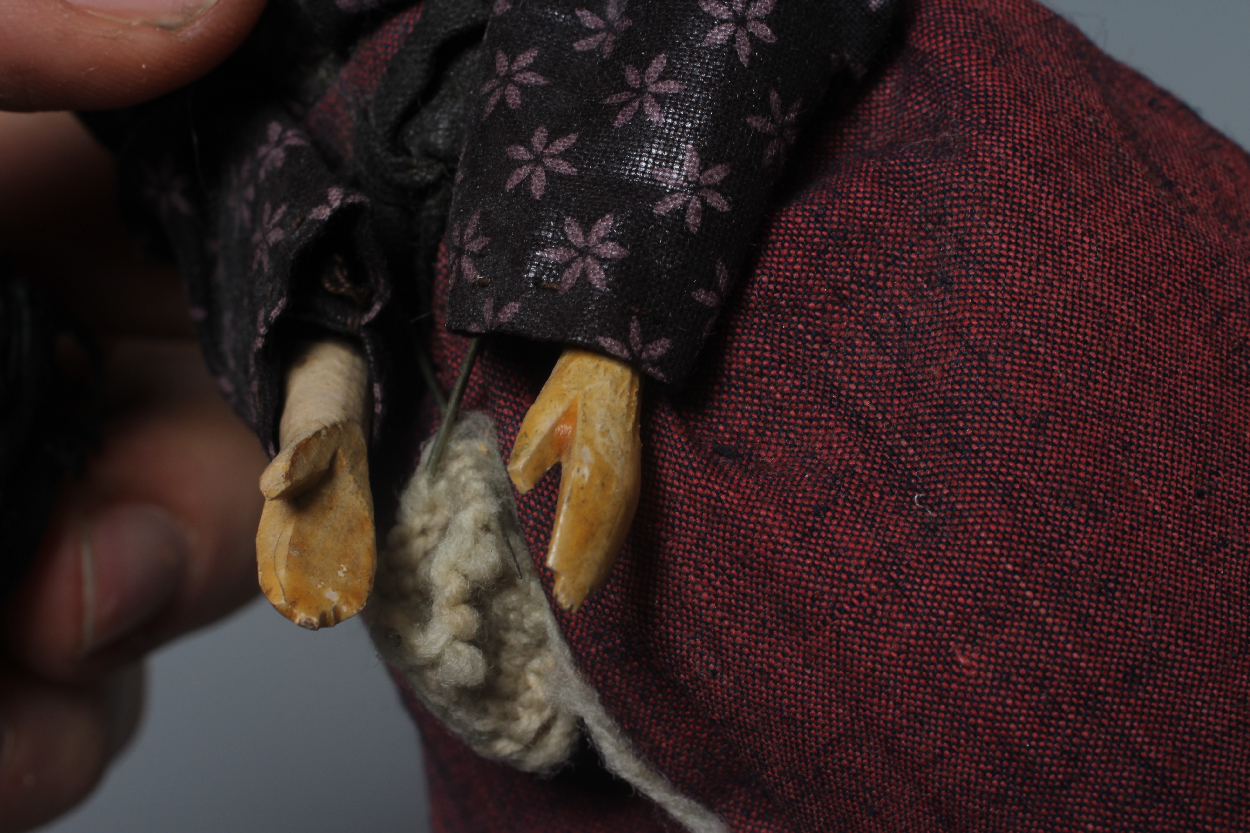 A rare Victorian wooden doll, with carved and painted face, fabric body, wooden lower limbs and Image