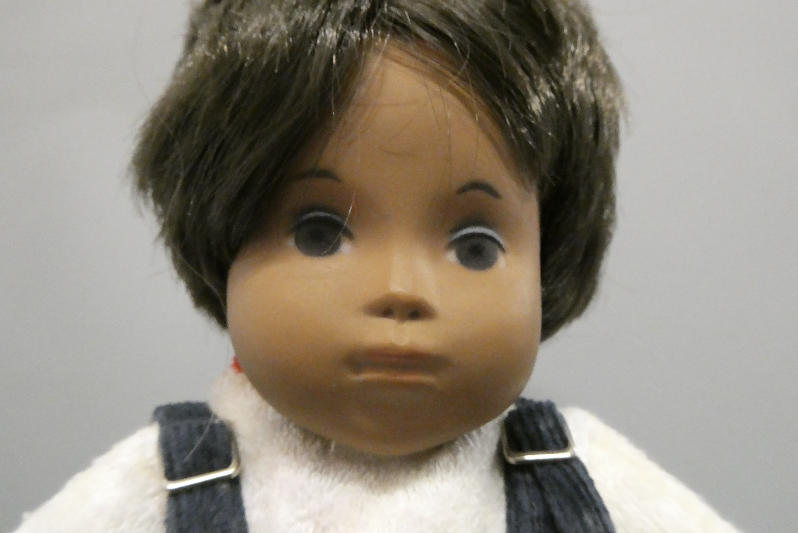 A Sasha toddler, with brown hair and original outfit including dungarees and shoes, 11" long (Est. Image