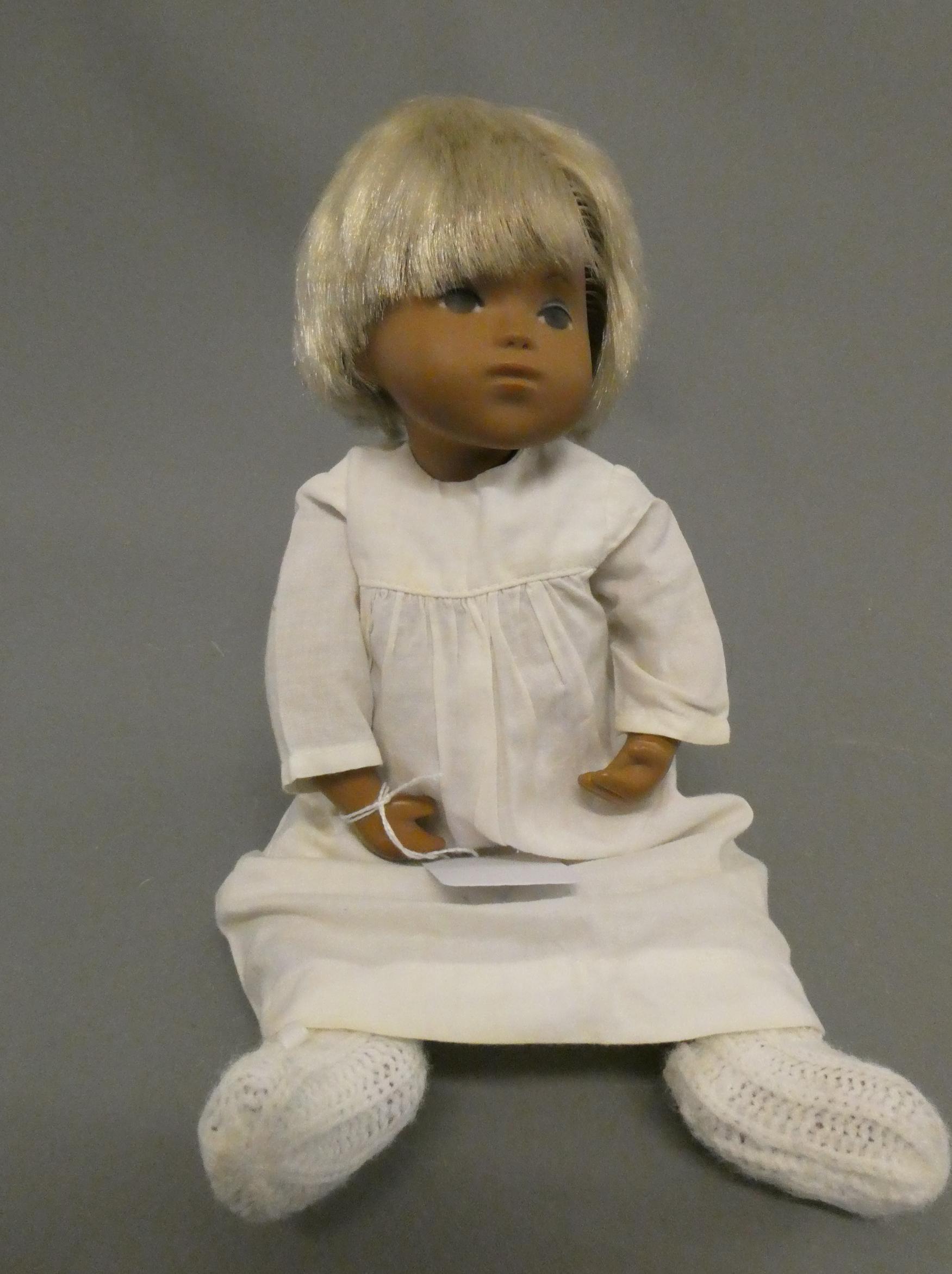 A Sasha baby, with blond hair and white outfit including knitted socks, 11 3/4" long (Est. plus 24% Image