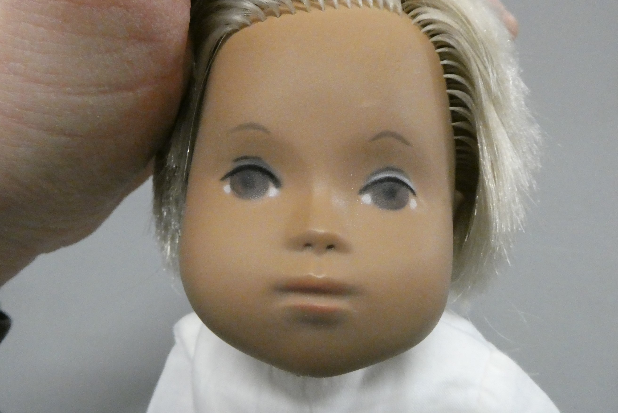 A Sasha baby, with blond hair and white outfit including knitted socks, 11 3/4" long (Est. plus 24% Image